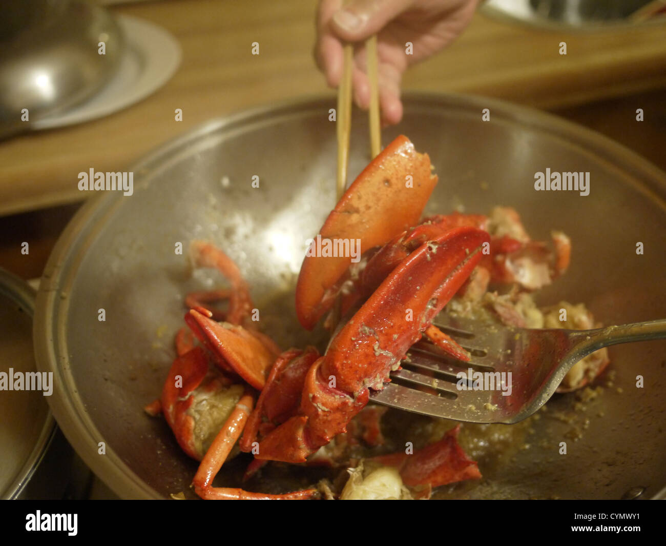 home cooked lobster wok chopsticks Stock Photo