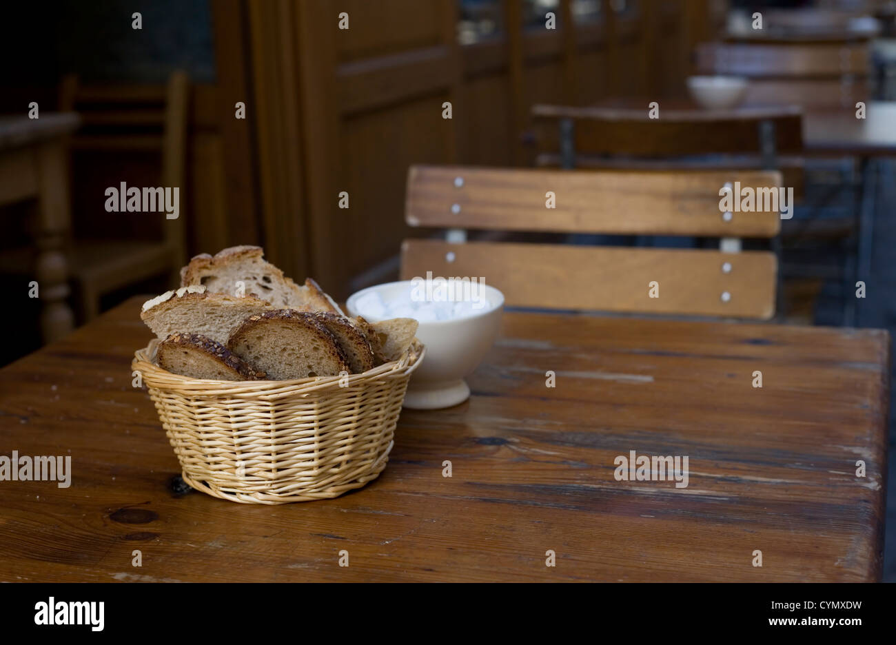 France. Restaurant table with crusty french bread in a basket and white