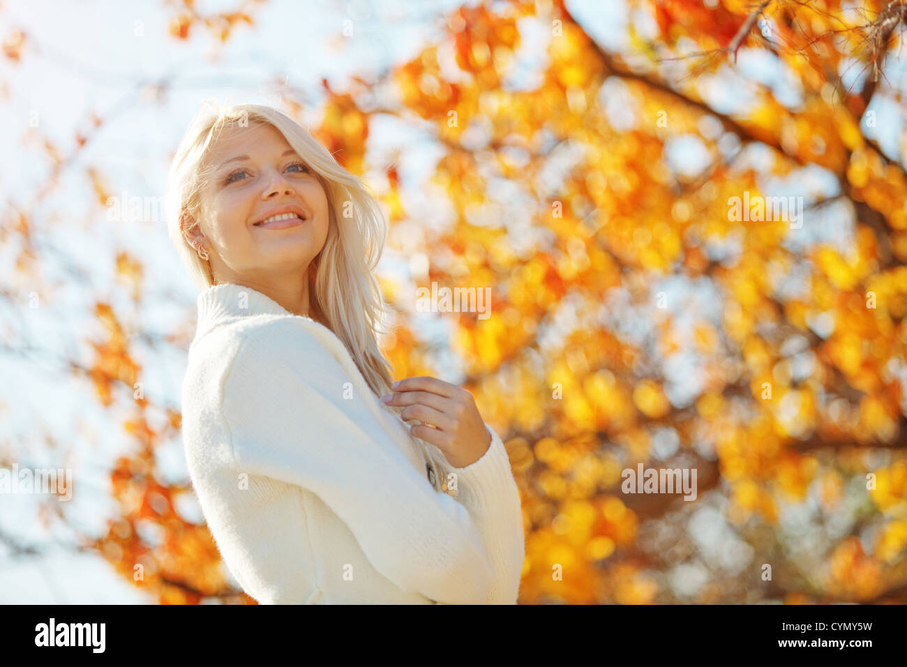 Portrait of beautiful young woman walking outdoors in autumn Stock ...