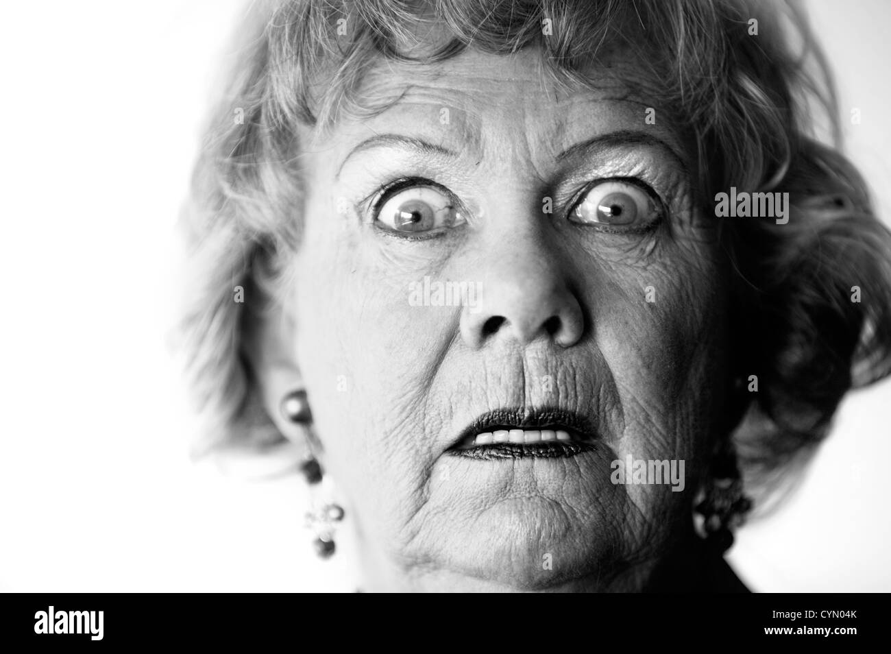 Close-up of a senior woman with a horrified look on her face. Stock Photo