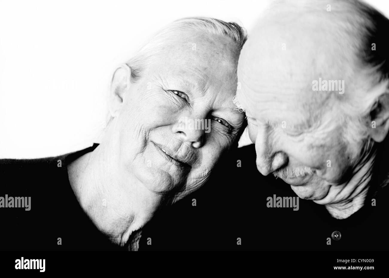 Close-up of senior couple embracing focuses on smiling woman Stock Photo