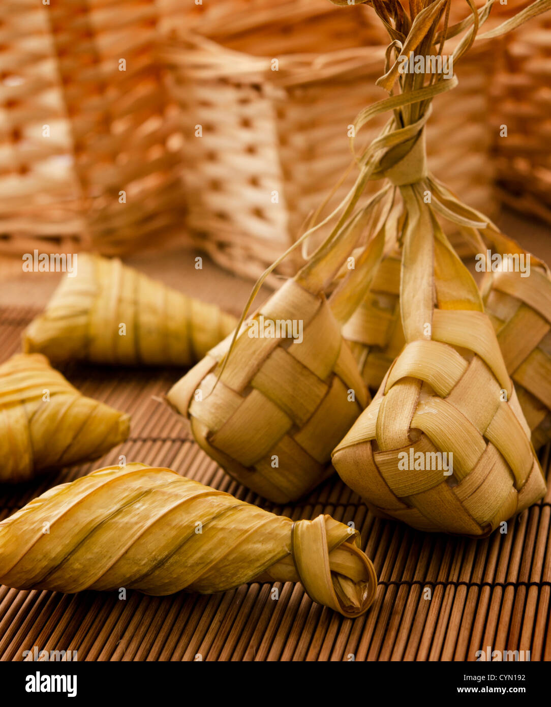 Asian cuisine ketupat or packed rice in low light setting. Stock Photo