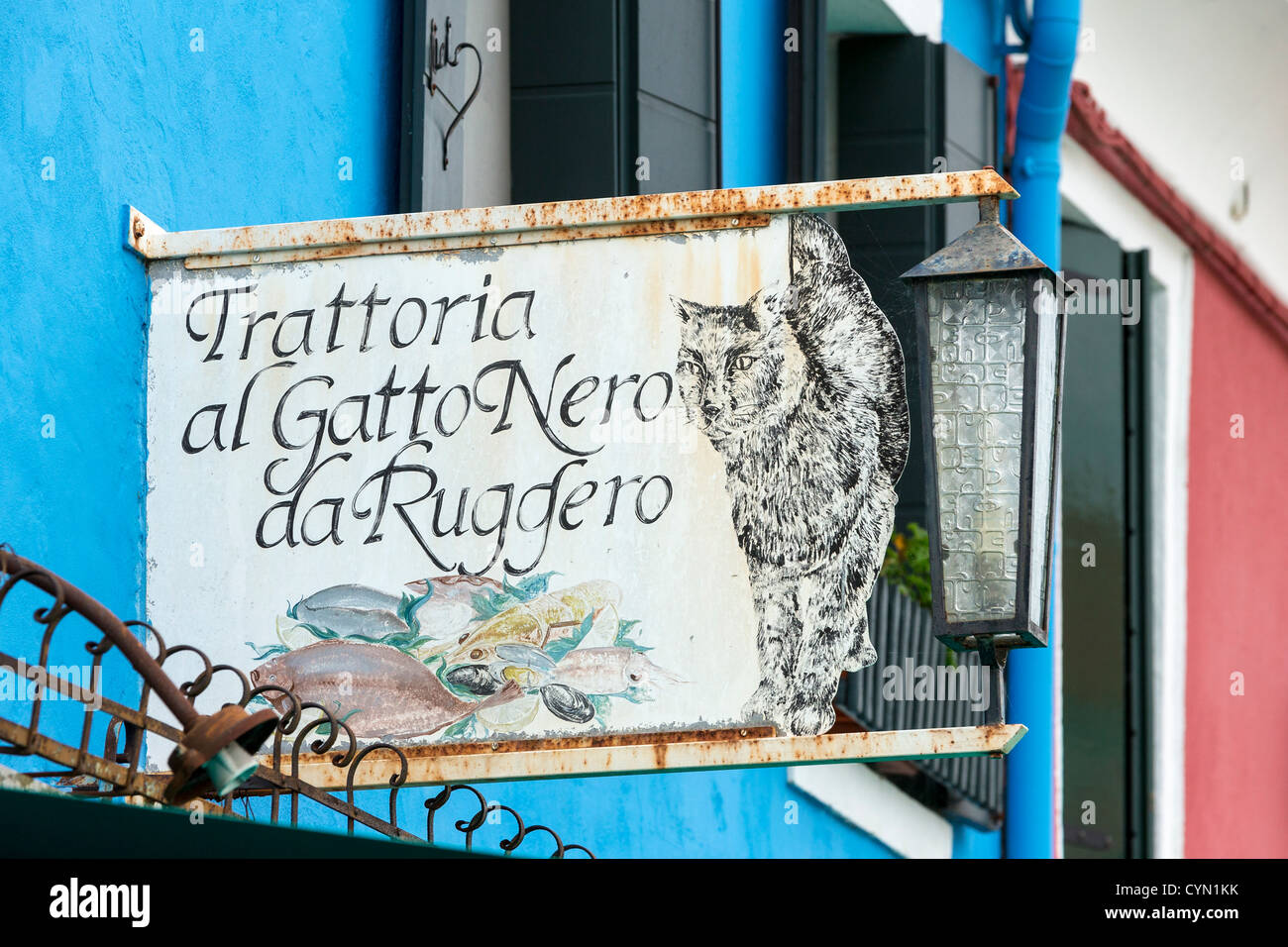 Sign advertising the Trattoria al Gatto Nero da Ruggero, a fish restaurant in Burano, Venice Stock Photo