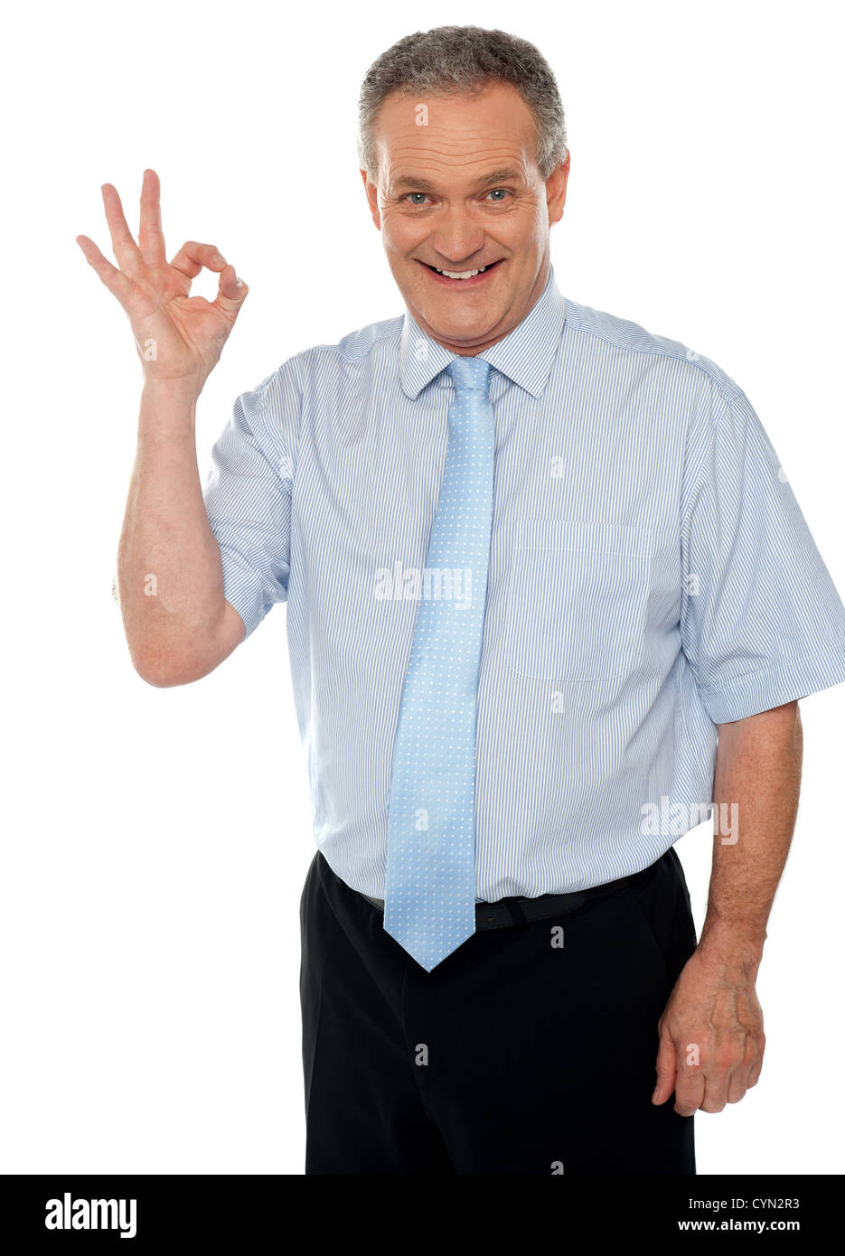 Cheerful male executive showing okay sign to camera. Isolated on white ...