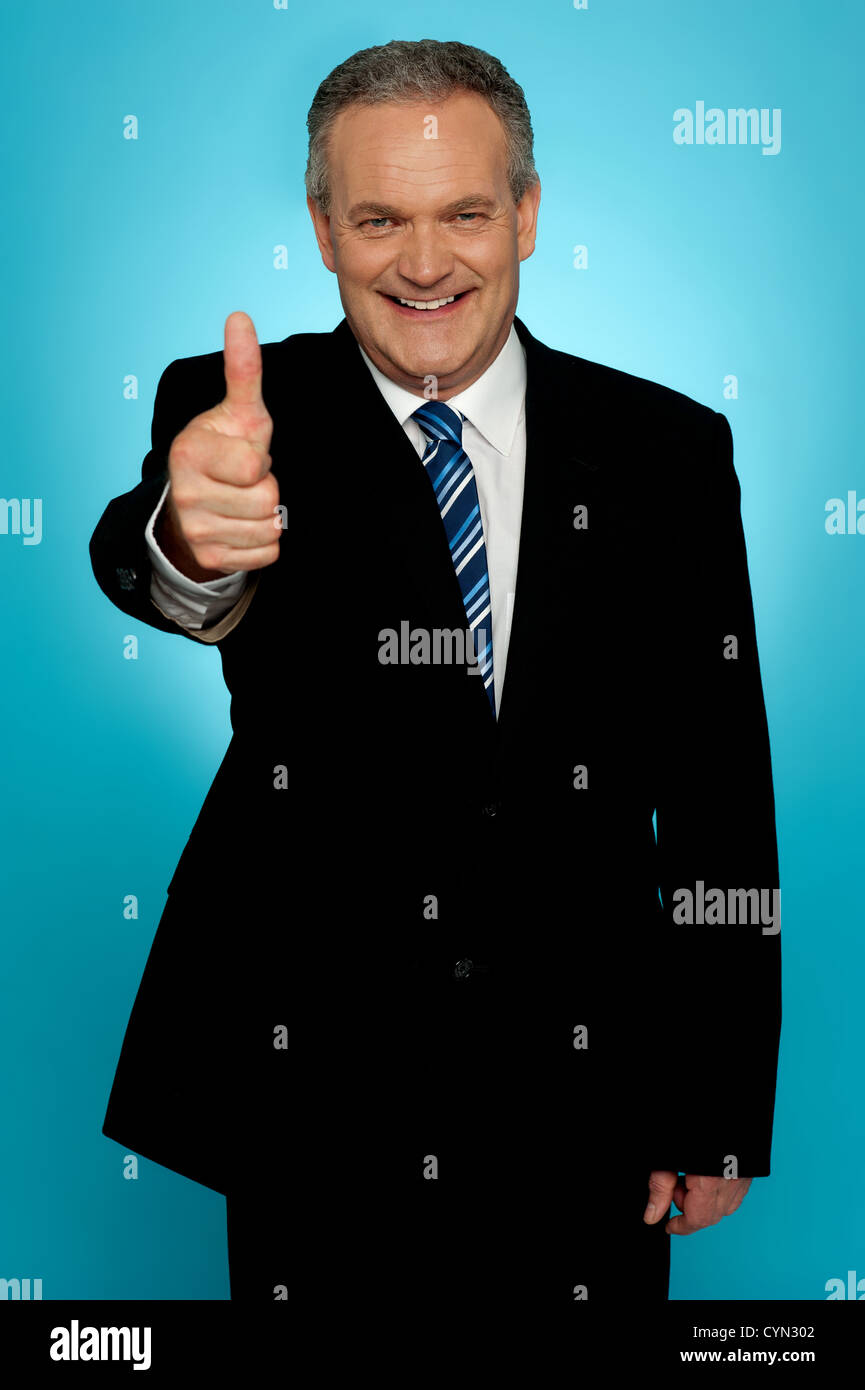 Isolated corporate man showing thumbs up to camera Stock Photo