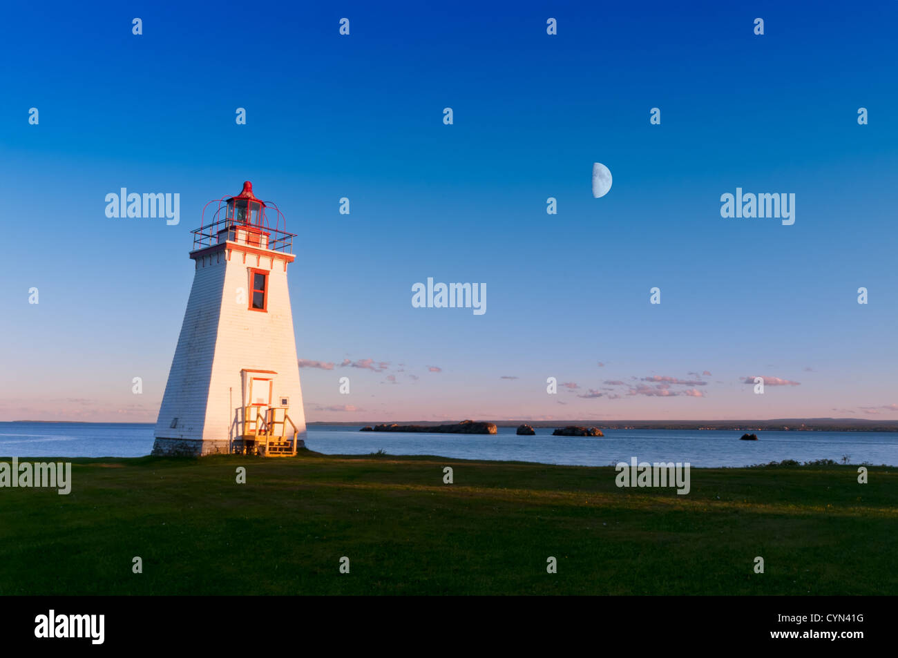 Lighthouse in the light from moon and sun beautiful colors Stock Photo