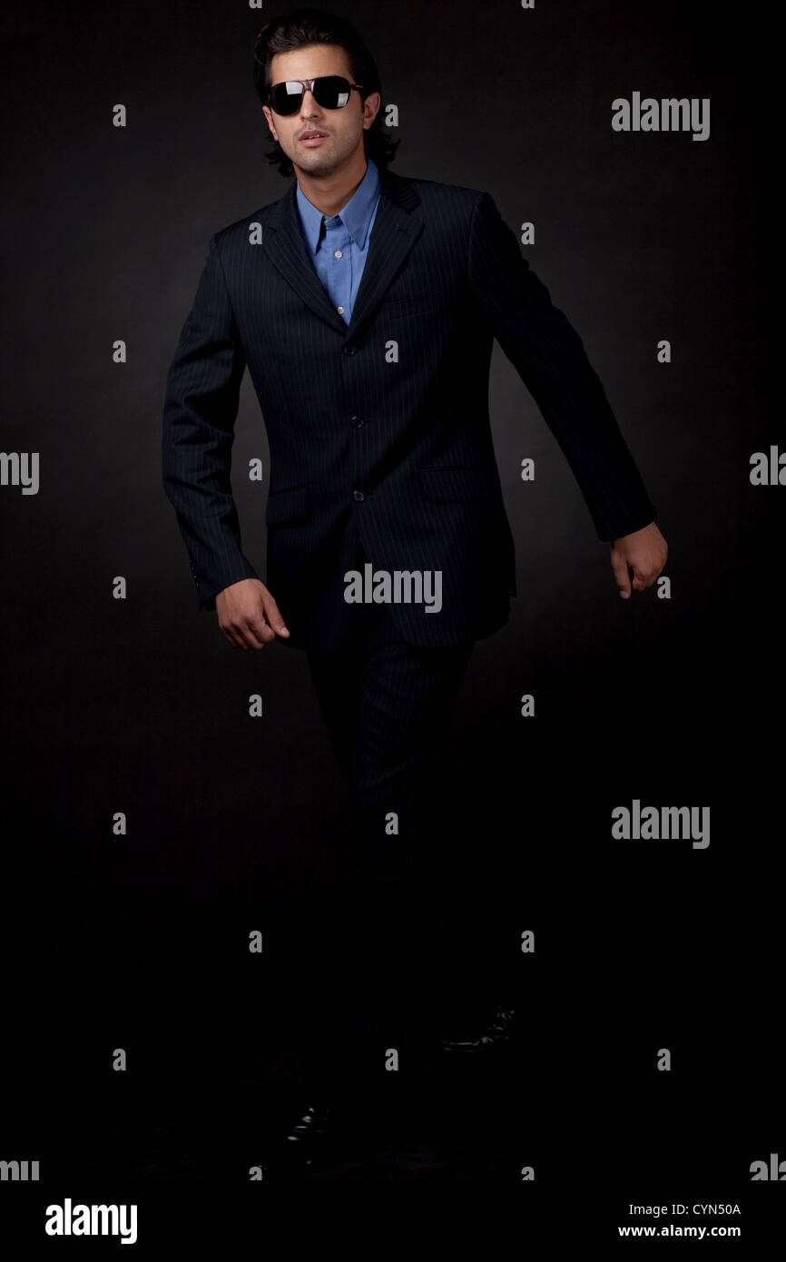 Men in black suit walking hi-res stock photography and images - Alamy