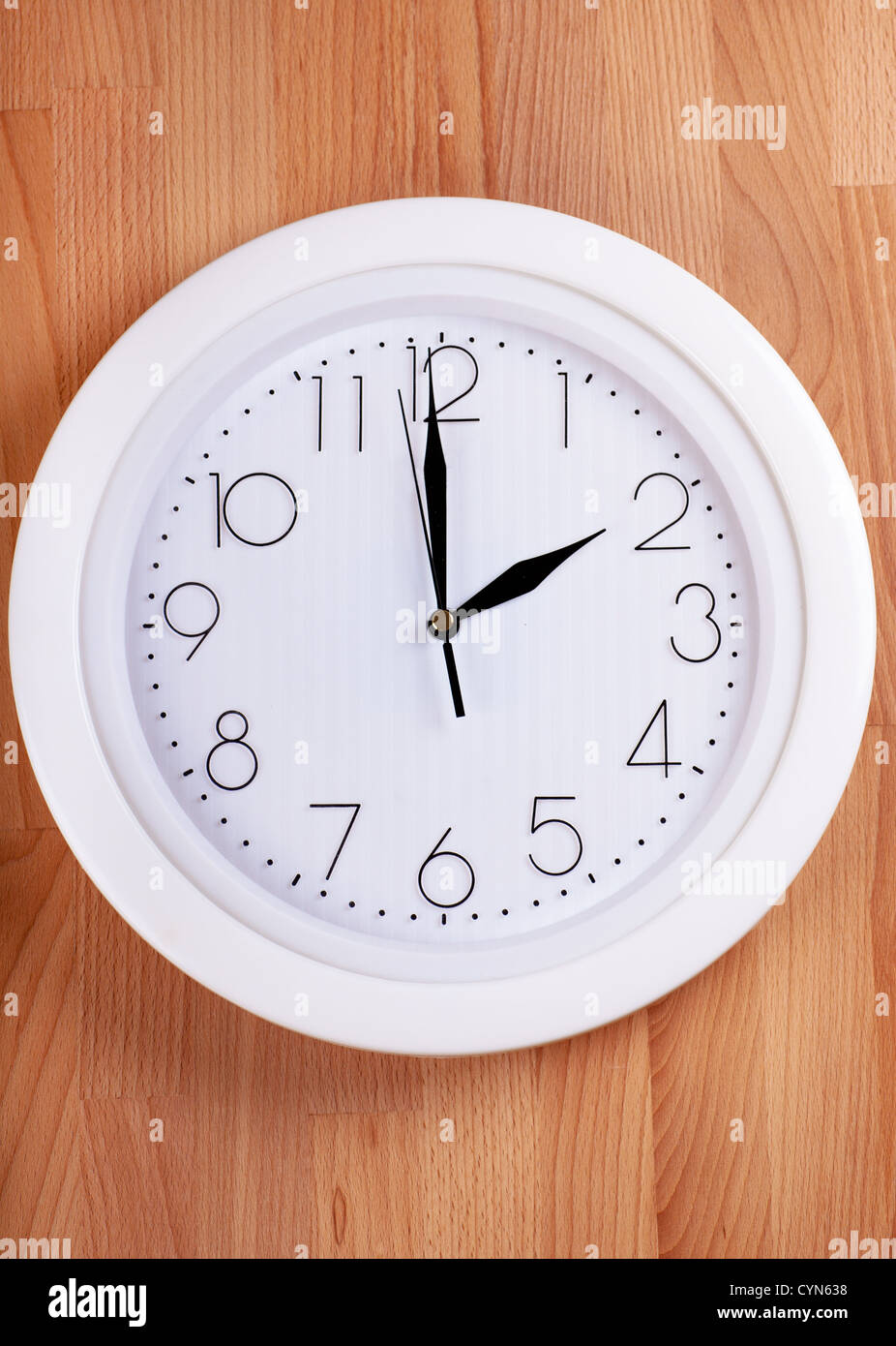 White clock hanging on a wooden wall Stock Photo Alamy
