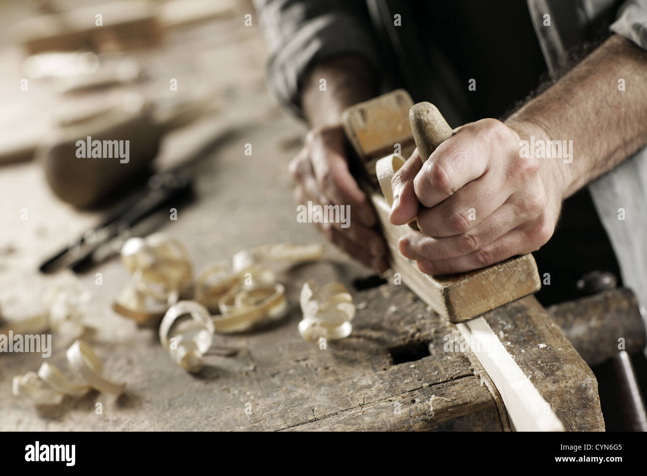 Hands of a carpenter planed wood, workplace Stock Photo