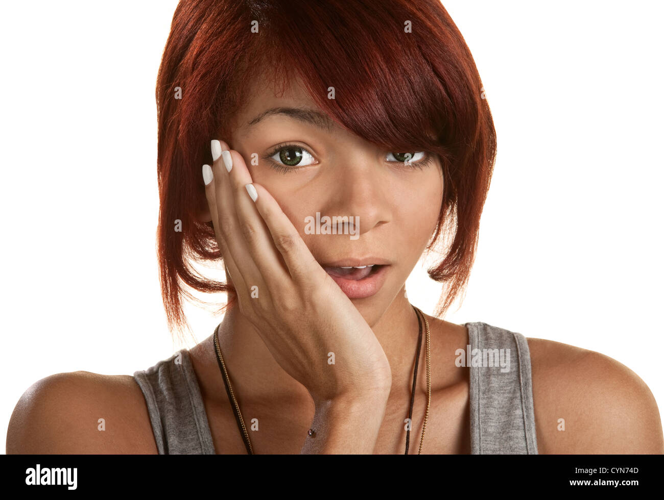 Cute surprised teenage girl with hand on cheek Stock Photo
