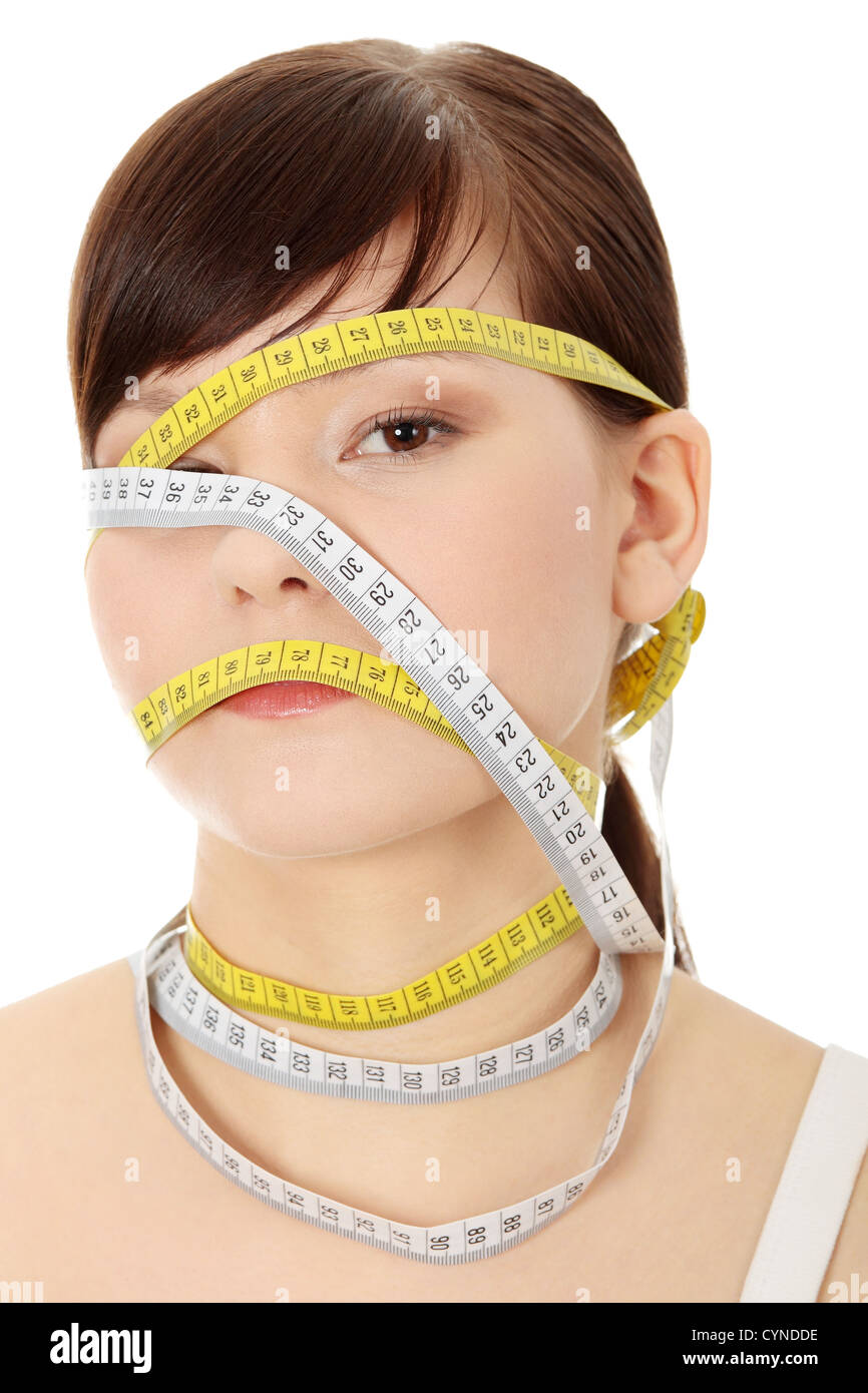 Young woman with measuring tape around her head, isolated on white
