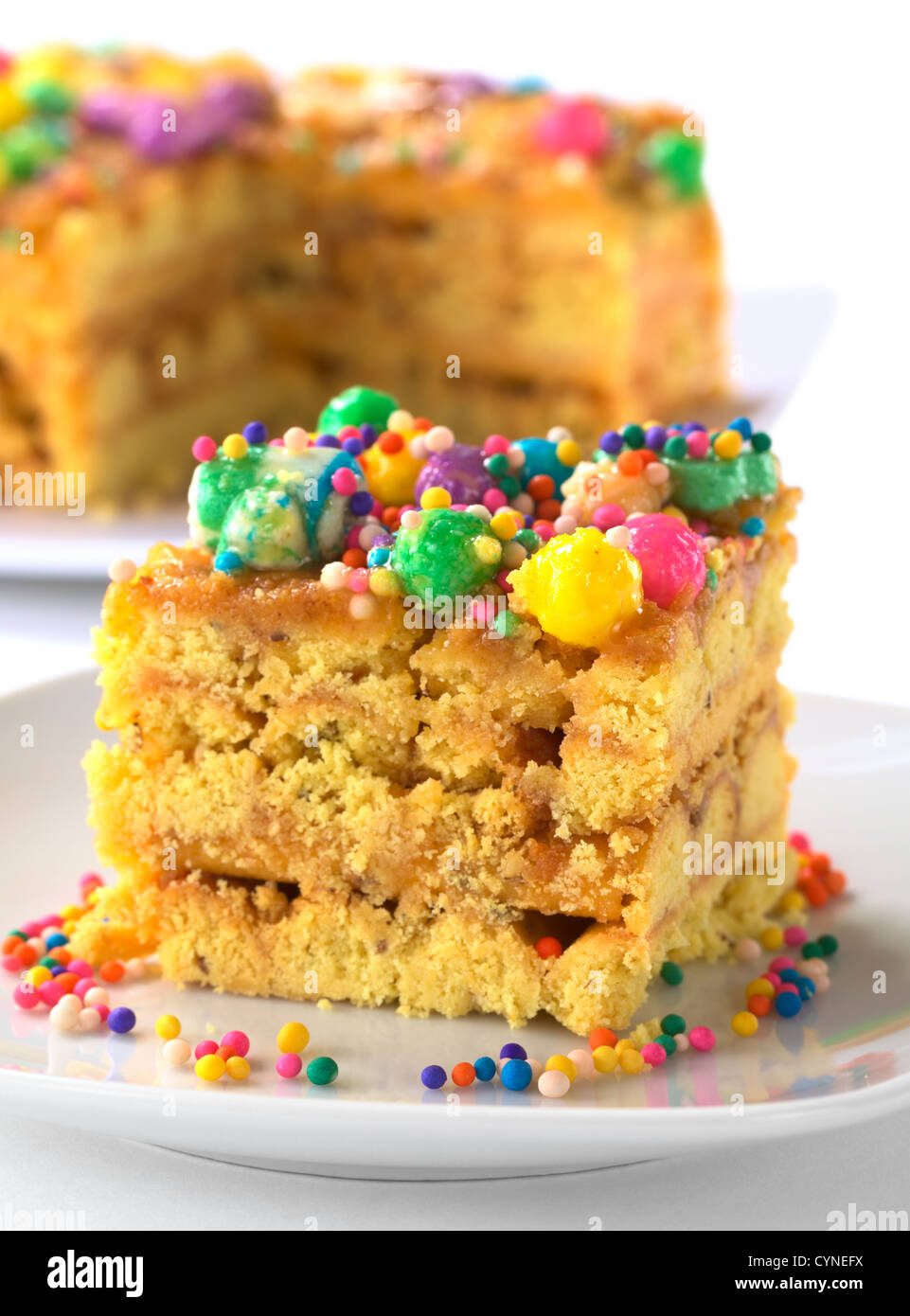 Peruvian colorful cake called Turron flavored with anis, sesame, dried fruits and honey, garnished with colorful sweets on top Stock Photo