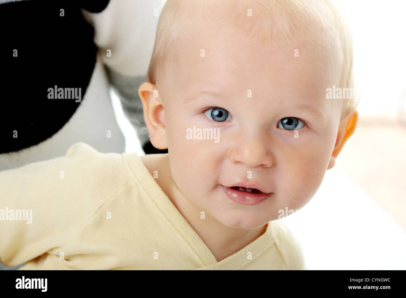 Bright closeup portrait of adorable baby boy and his mom Stock Photo