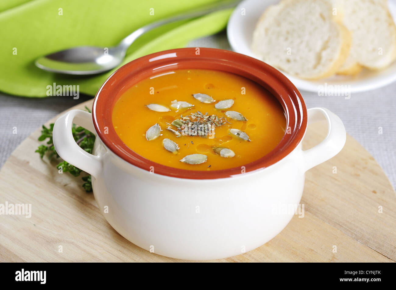Pumpkin cream soup with pumpkin seeds and dried herbs  Stock Photo