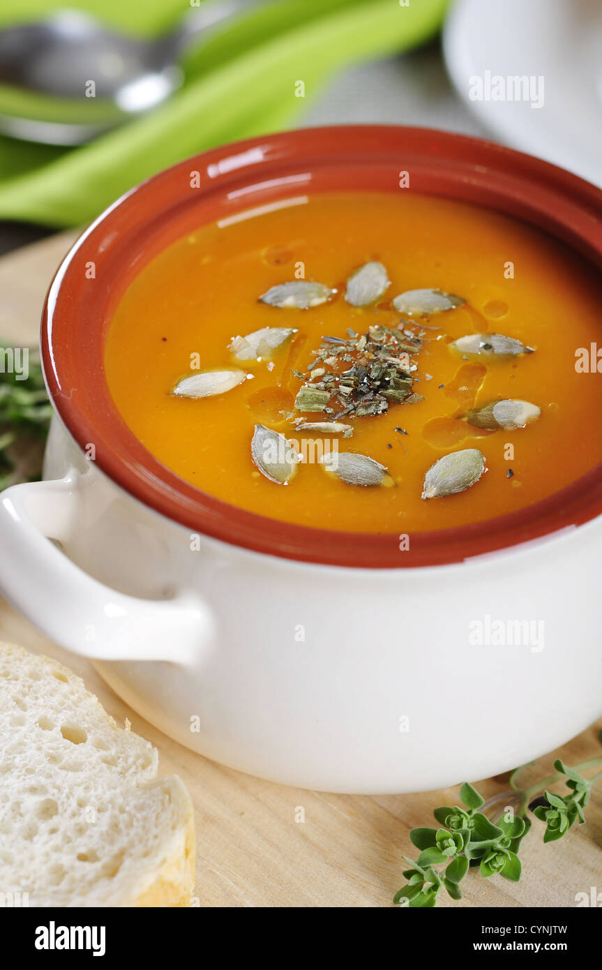 Pumpkin cream soup with pumpkin seeds and dried herbs Stock Photo