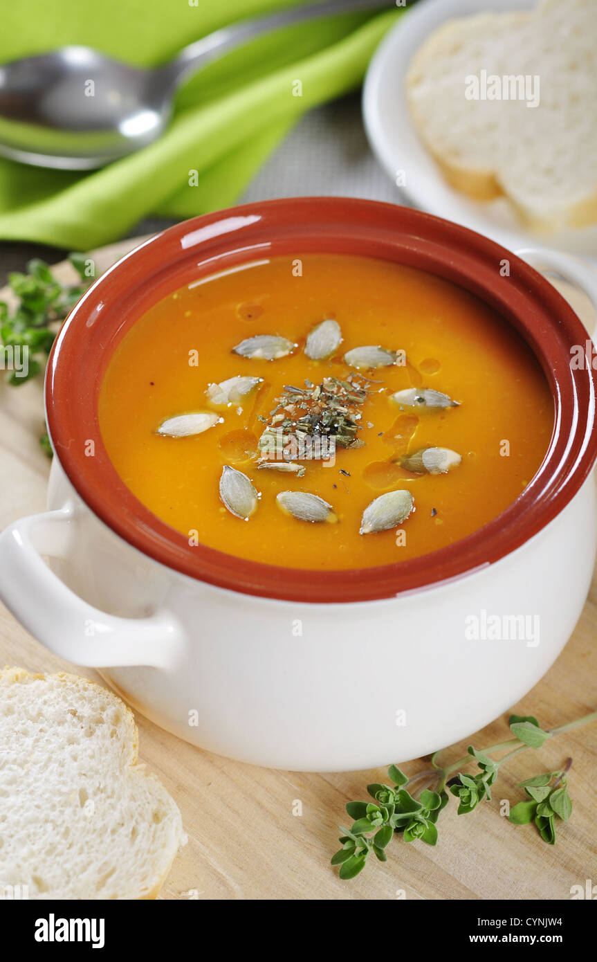 Pumpkin cream soup with pumpkin seeds and dried herbs Stock Photo