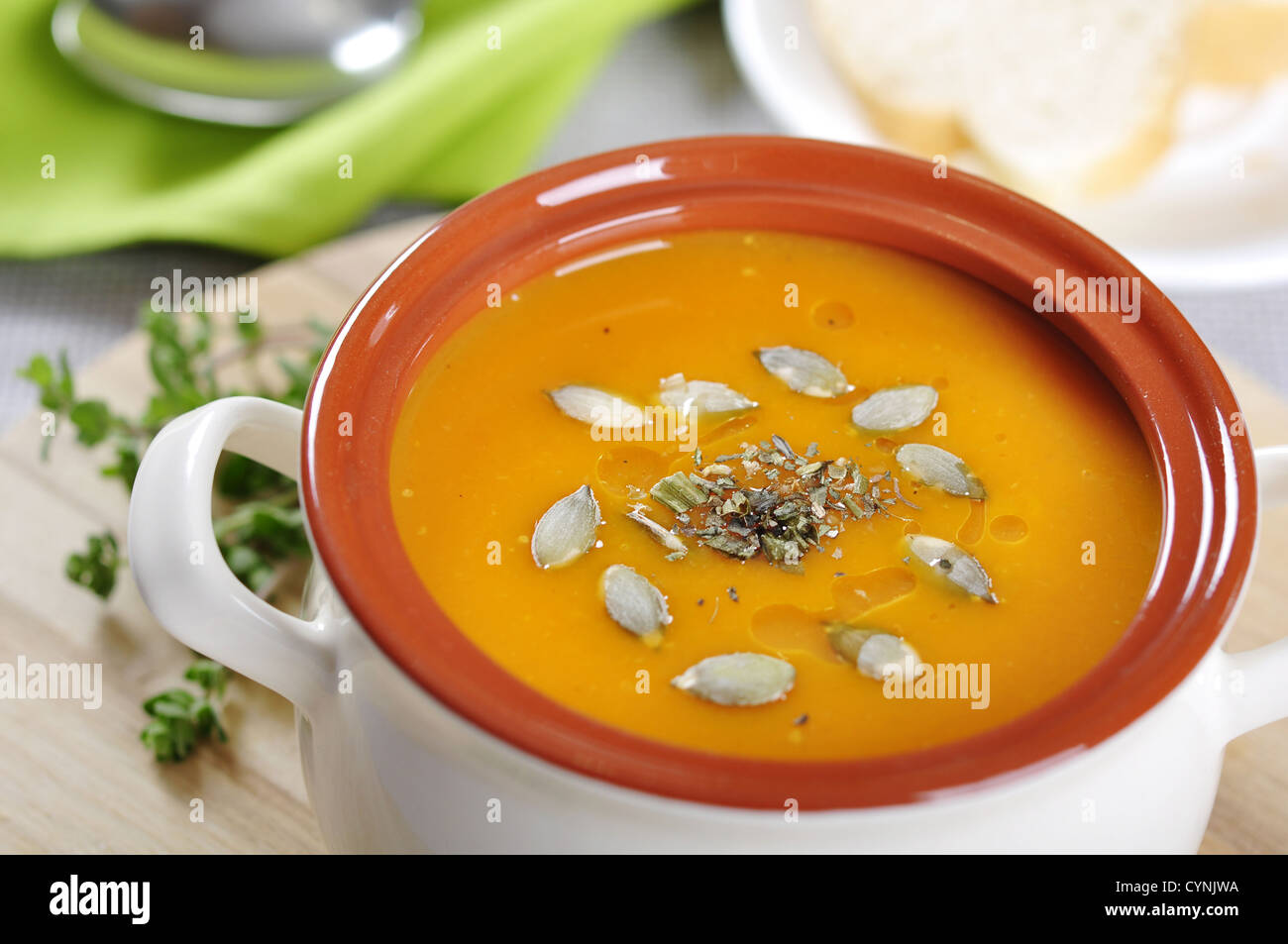 Pumpkin cream soup with pumpkin seeds and dried herbs Stock Photo