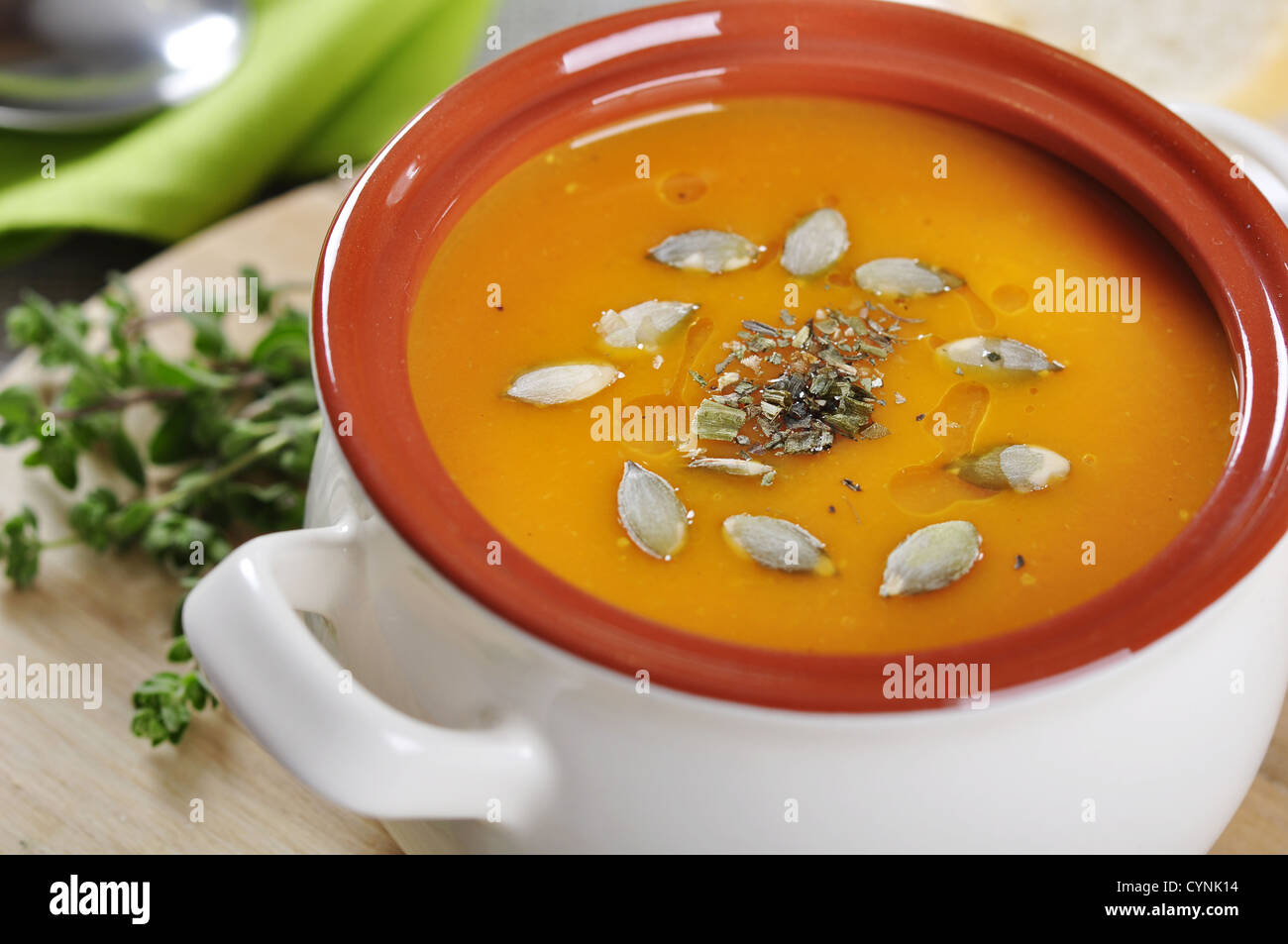 Pumpkin cream soup with pumpkin seeds and dried herbs Stock Photo