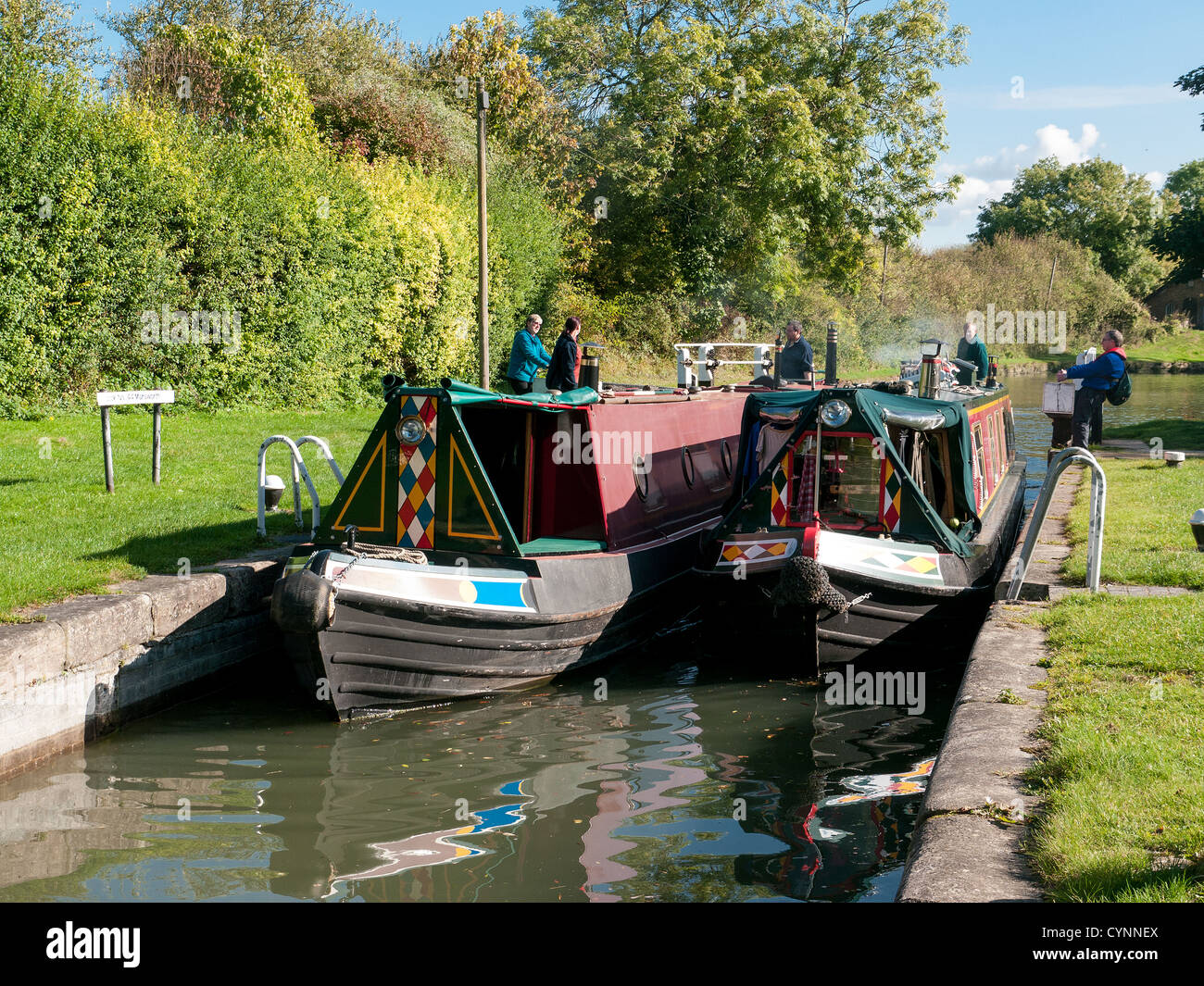 Two narrow boats in a lock on the Grand Union Canal at Marsworth, Buckinghamshire, UK Stock Photo