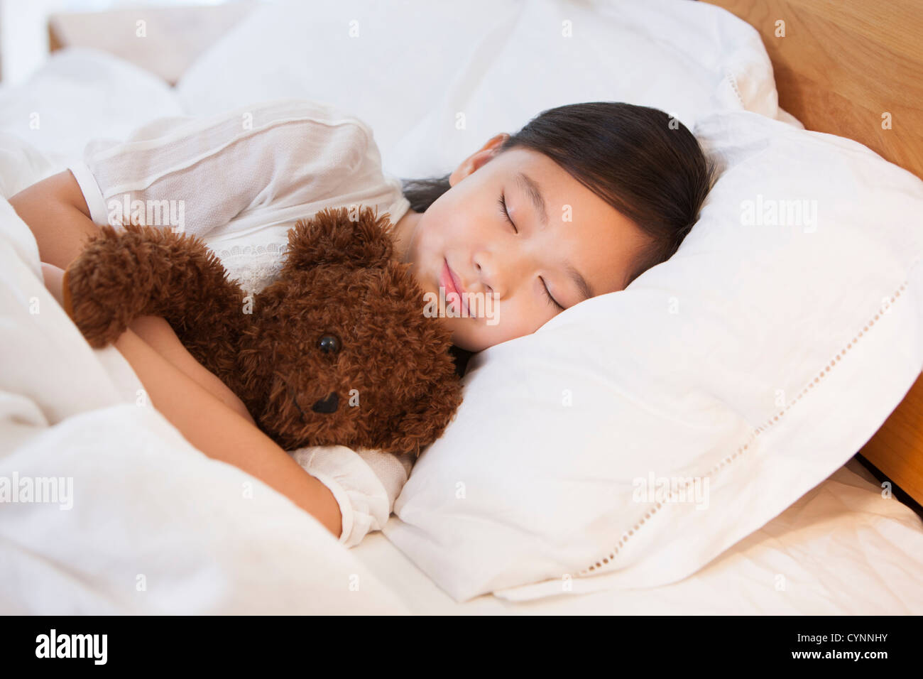 Little girl sleeping soundly with teddy bear Stock Photo - Alamy