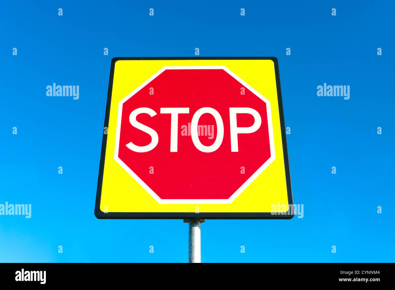 new traffic shield of a red stop sign in fluorescent yellow Stock Photo