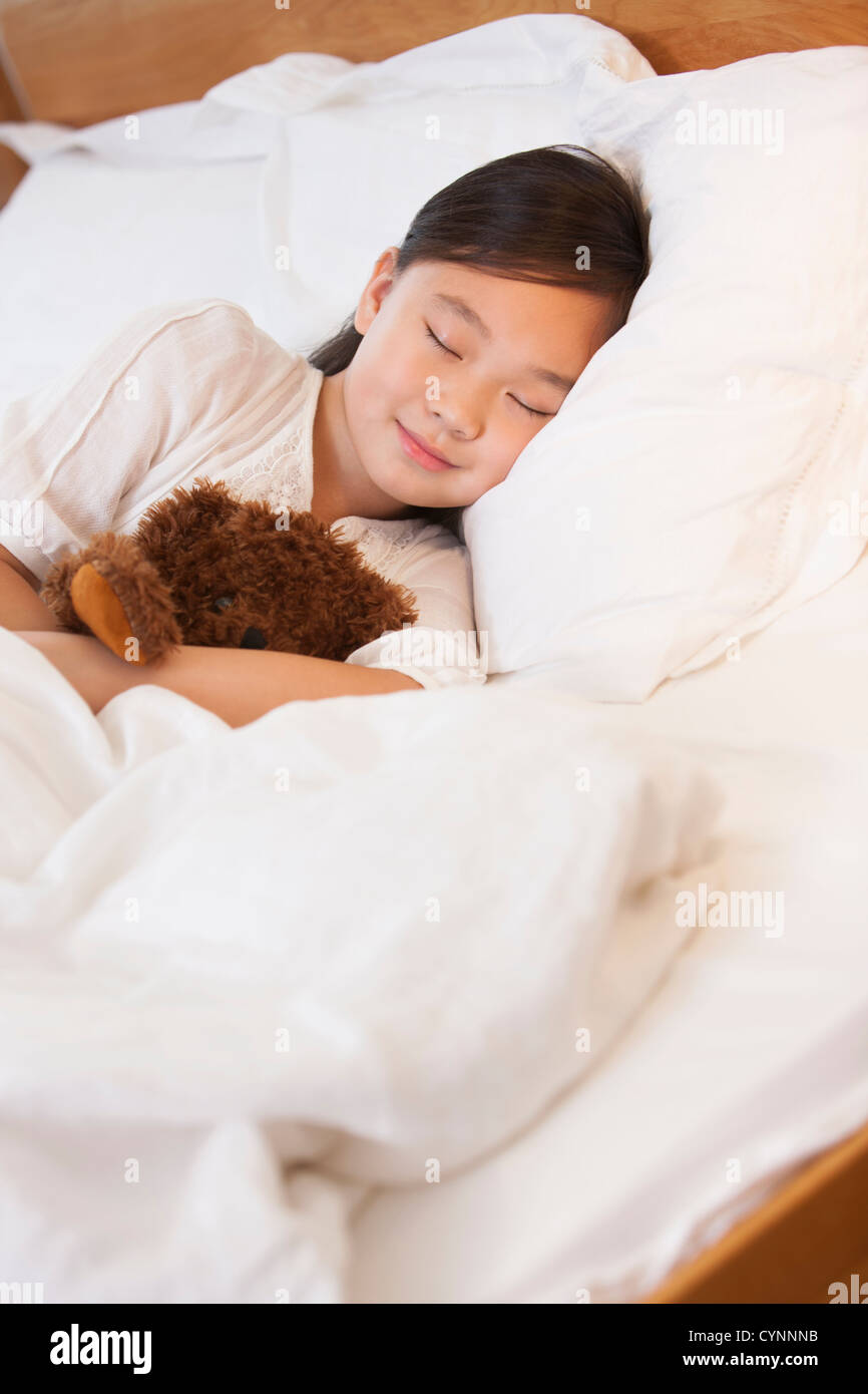 Little girl sleeping soundly with teddy bear Stock Photo - Alamy