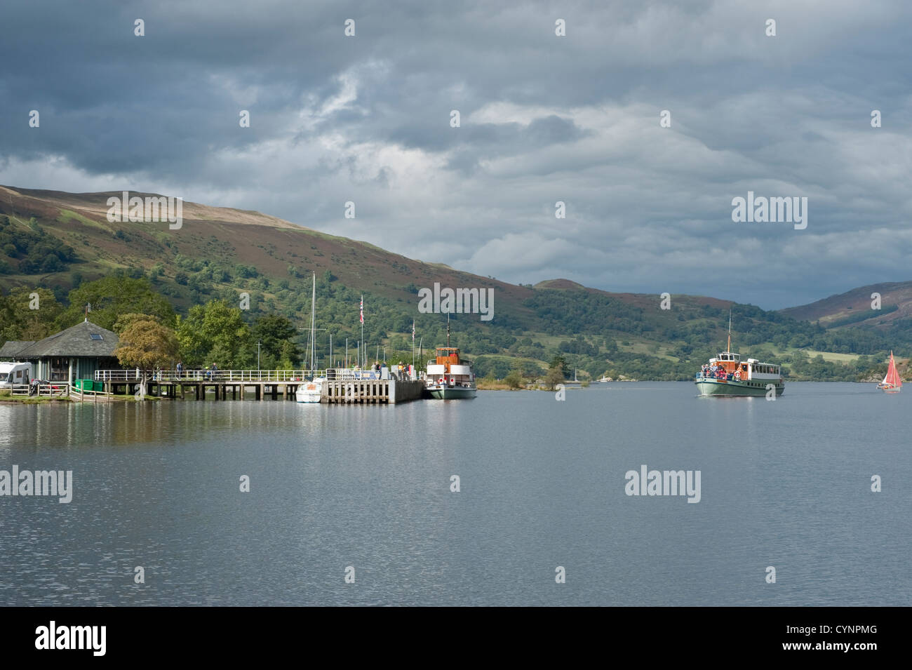 Passenger steam boat arriving at Glenridding pier on Lake Ullswater in the English Lake District Stock Photo