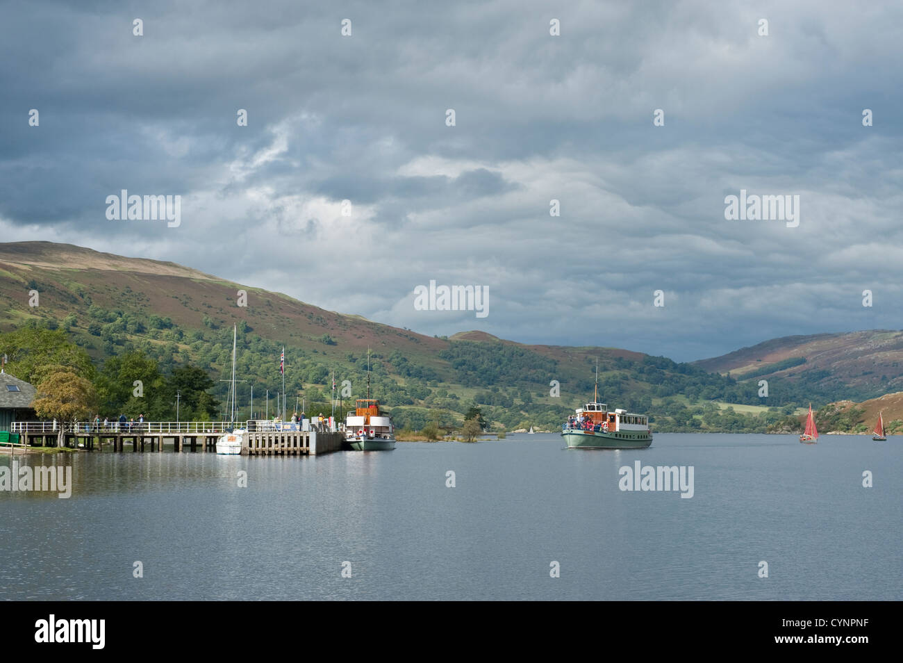 Passenger steam boat arriving at Glenridding pier on Lake Ullswater in the English Lake District Stock Photo