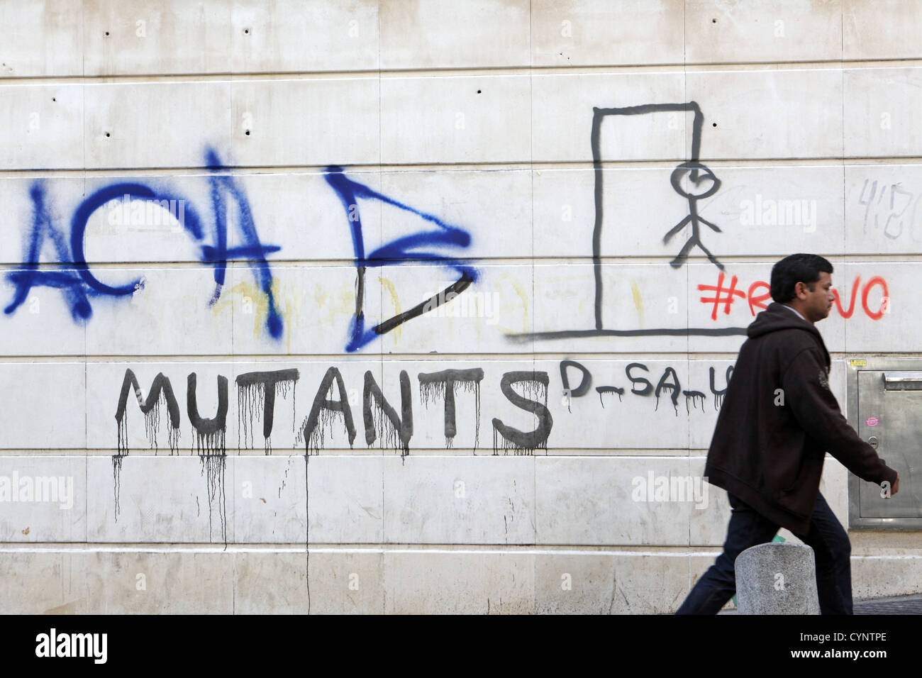 Man walking past graffiti wall painting Mutants, self-expression, Madrid, Spain, Espana Stock Photo