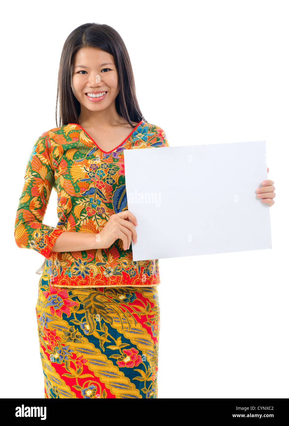 Asian woman in batik dress holding a placard over white background Stock Photo