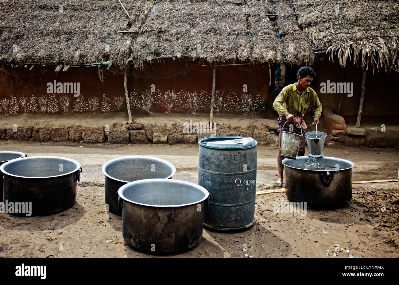 Man lifting heavy buckets with water Stock Photo Alamy