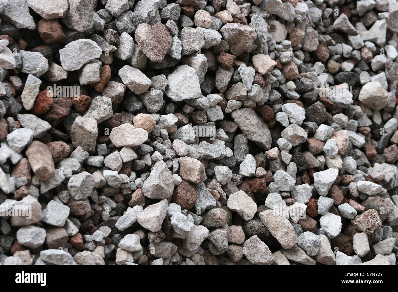 An abstract pile of multicolored rocks in a variety of shapes and sizes ...