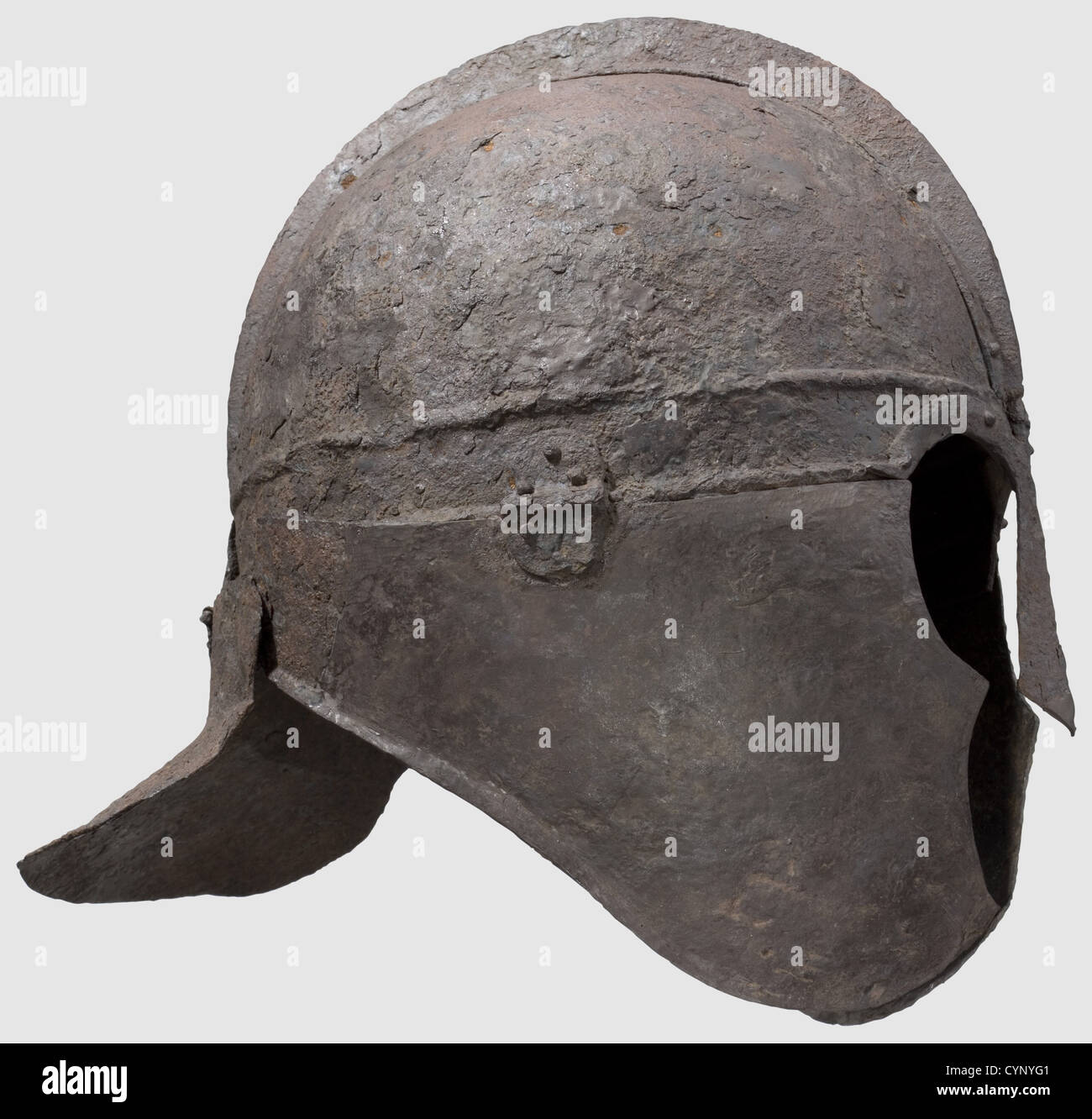 A late Roman iron helmet,circa 4th/5th century A.D.Formed of several sections hinged and riveted in place,the domed cap with a brow band off set by horizontal ribs,the two halves of the cap joined to a central ridge by rivets,the nose-guard and ornamental arching brows riveted to the brow band,the cheek-pieces flanged toward the neck and hinged to the brow band,each perforated below the chin,the neck-guard with an everted hemispherical flange hinged to the back of the brow band Height 27.5 cm,Weight 1426 grams.Provenance: American Private Collection,,Additional-Rights-Clearences-Not Available Stock Photo