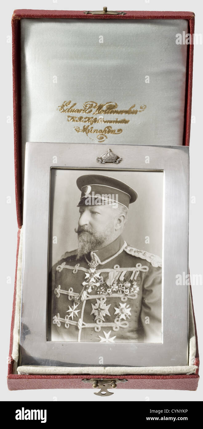 Tsar Ferdinand of Bulgaria (1861 - 1948) - dedication frame, for a photograph with a picture of the Tsar. Smooth silver frame, dimensions 12 x 16 cm, on top a superimposed, silver tsarist crown. Punched at the bottom 'Wollenweber 800'. The reverse side made from red morocco leather with a stand. The photograph shows Ferdinand in his hussar uniform. With it a presentation case with manufacturer's inscription of the silversmith to the Bavarian court, Eduard Wollenweber, people, 19th century, object, objects, stills, clipping, clippings, cut out, cut-out, cut-outs, Stock Photo