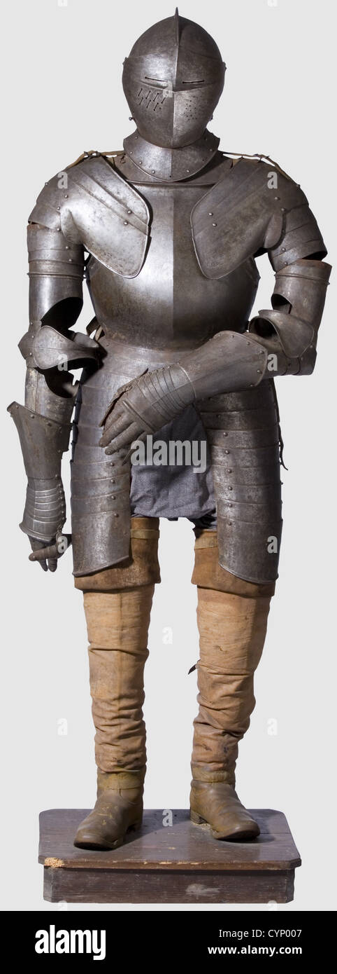A composite German armour,circa 1600.Assembled from old parts.Additions from the historism period.A close-helmet,the skull worked in two pieces joined by a shallow comb.The bevor with medial ridge and spring-loaded latch on the side,added visor with separated sight as well as sliced and perforated breaths.Riveted throat and neck guard and added feather plume socket.Articulated gorget of two plates opening on hinges.Large pauldrons sliding on six plates with pendent closed upper and lower cannons.Attached fingered gauntlets(lames complete)with metac,Additional-Rights-Clearences-Not Available Stock Photo