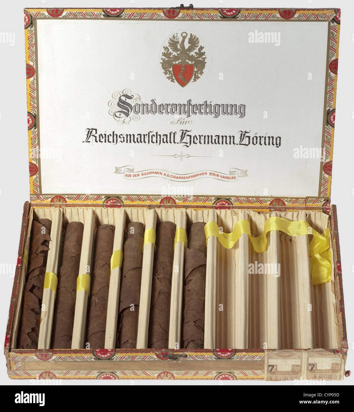 Hermann Göring - a cigar box with six cigars,from the 'Sonderanfertigung für Reichsmarschall Hermann Göring '(Specially Made for Reichsmarschall Hermann Göring).The cigars unprotected in the box,the wrappers dissolved.The wooden box is richly ornamented with decorative stripes.The lid has Göring's coat of arms in gold relief on the outside,the inside lid bears the above mentioned inscription with his coat of arms above the manufacturer's scroll,reading 'aus den Gildemann A.G.Cigarrenfabriken Berlin-Hamburg'(from Gildemann Ltd.Cigar Manufacturers Berl,Additional-Rights-Clearences-Not Available Stock Photo