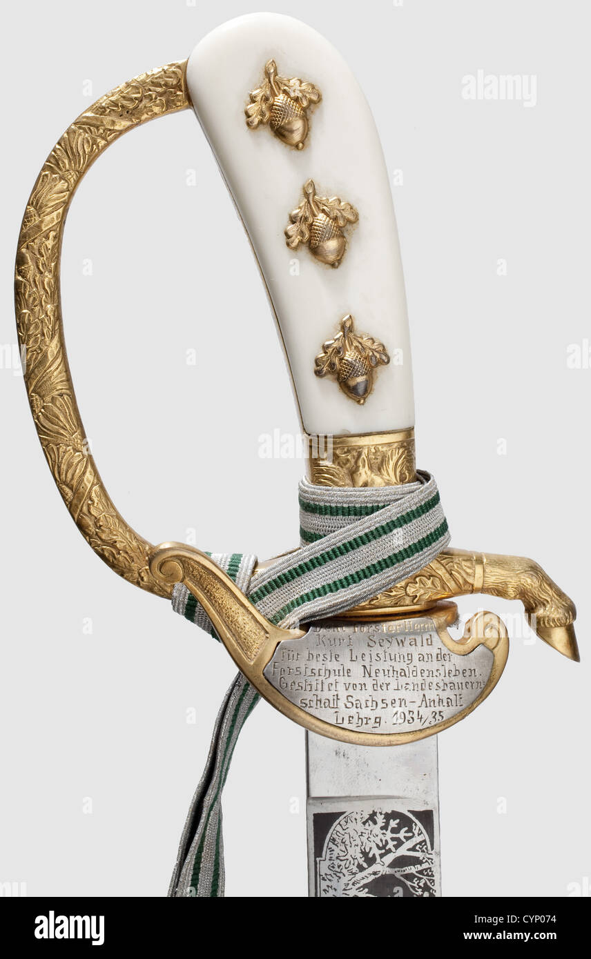 A hunting hanger for outstanding service in Forestry School Neuhaldensleben,Massive single-edged blade with hunting motifs etched on both sides.Gilt knuckle-bow hilt in relief with floral decoration,the front quillon terminating in a hoof,the grip shows a small squirrel as a hidden logo of maker 'Eickhorn/Solingen',the guard bears an applied silver plaque engraved 'Dem Förster Herrn Kurt Seywald für beste Leistung in der Forstschule Neuhaldensleben.Gestiftet von der Landesbauernschaft Sachsen-Anhalt 1934/35.(To Forester Mr.Kurt Seywald for best serv,Additional-Rights-Clearences-Not Available Stock Photo