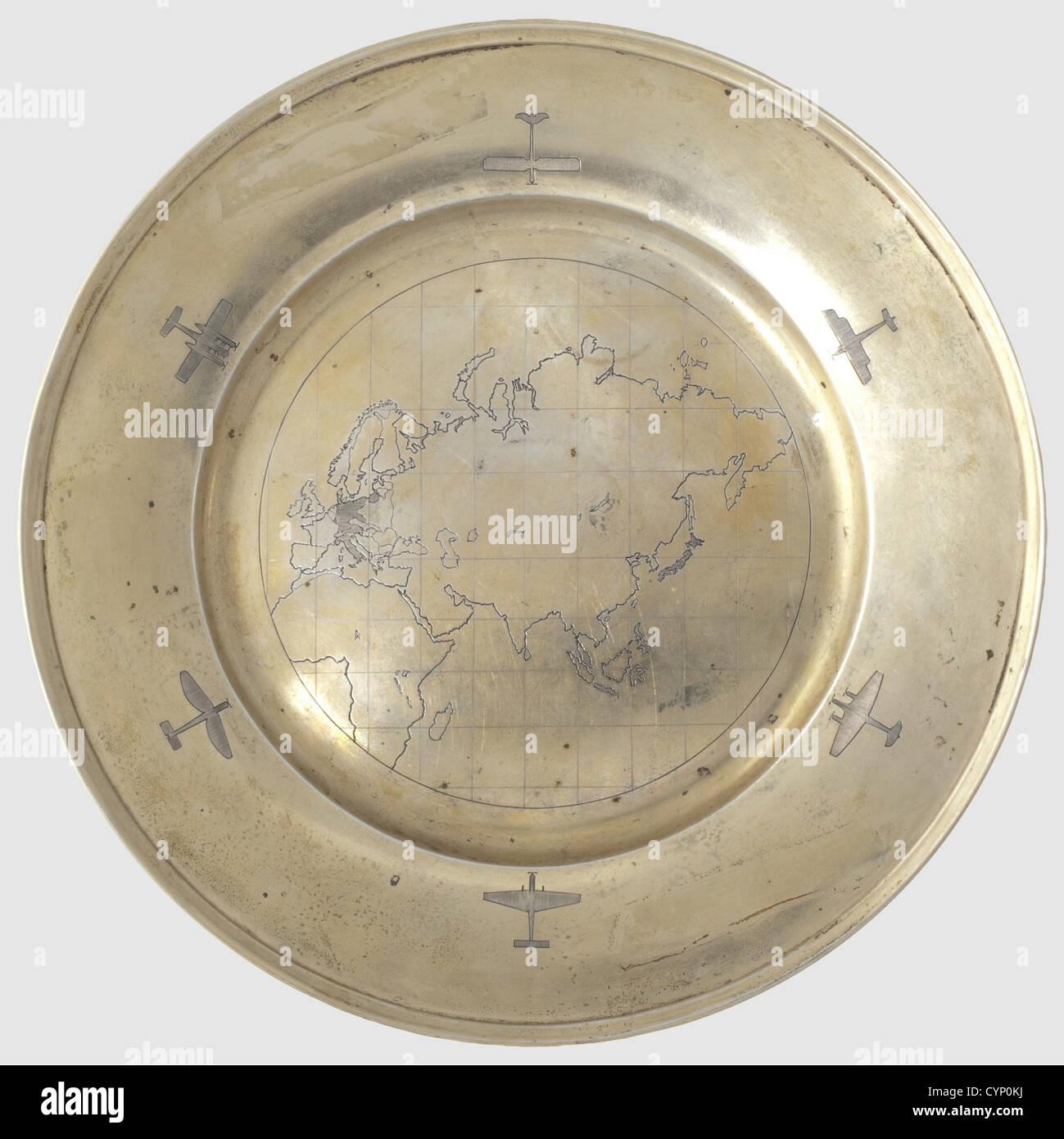 Hermann Göring - a vermeil plate 1939,Silver,gilt,the border engraved predominantly with aircraft types of the Junkers firm. The centre displays an engraved map of the continents of Europe,Africa and Asia,the countries of the Axis hatched: Germany,East Prussia,Austria,Italy and Japan. The bottom marked 'Handarbeit' and '800' with crescent and crown. Diameter 22.2 cm,weight 329 g. Attached an old auction label from Phillips,auction 86,lot 490,historic,historical,1930s,20th century,Air Force,branch of service,branches of service,armed service,,Additional-Rights-Clearences-Not Available Stock Photo
