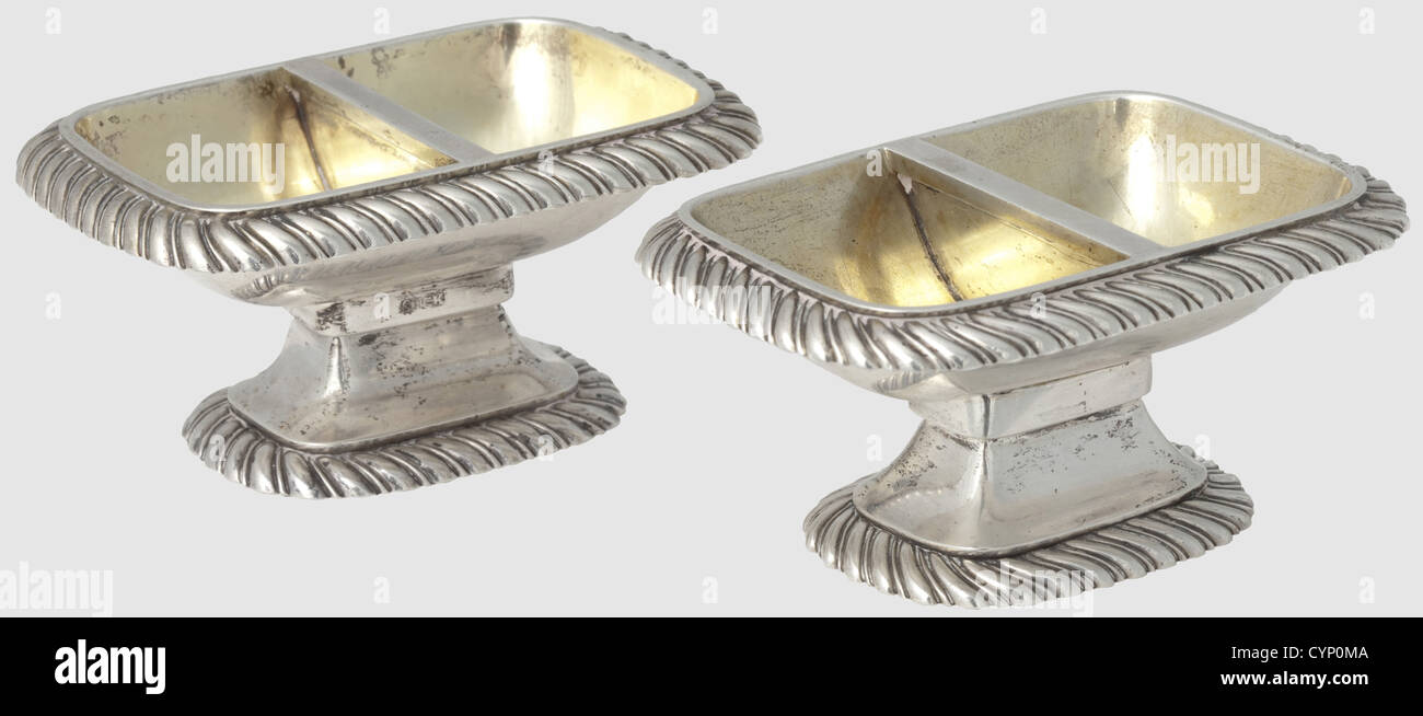 Jérôme Bonaparte and Katharina of Wuerttemberg - a pair of silver bowls for spices,circa 1807.Rectangular bowls,separated in the middle,with a gilt inside.Conical bases,continuous gadrooned border decorations.One exemplar with proofmark of Stuttgart from circa 1800 - 1810 and mark of the goldsmith to the court Johann Christian Sick(1766 - 1824).The second bowl with a beehive mark.Stamped owner's initials 'BJ'(Jérôme Bonaparte)and 'BK'(Katharina Bonaparte).Assayer's mark.On the bases stamped years for change of owner in 1835 and 1868,as well as l,Additional-Rights-Clearences-Not Available Stock Photo