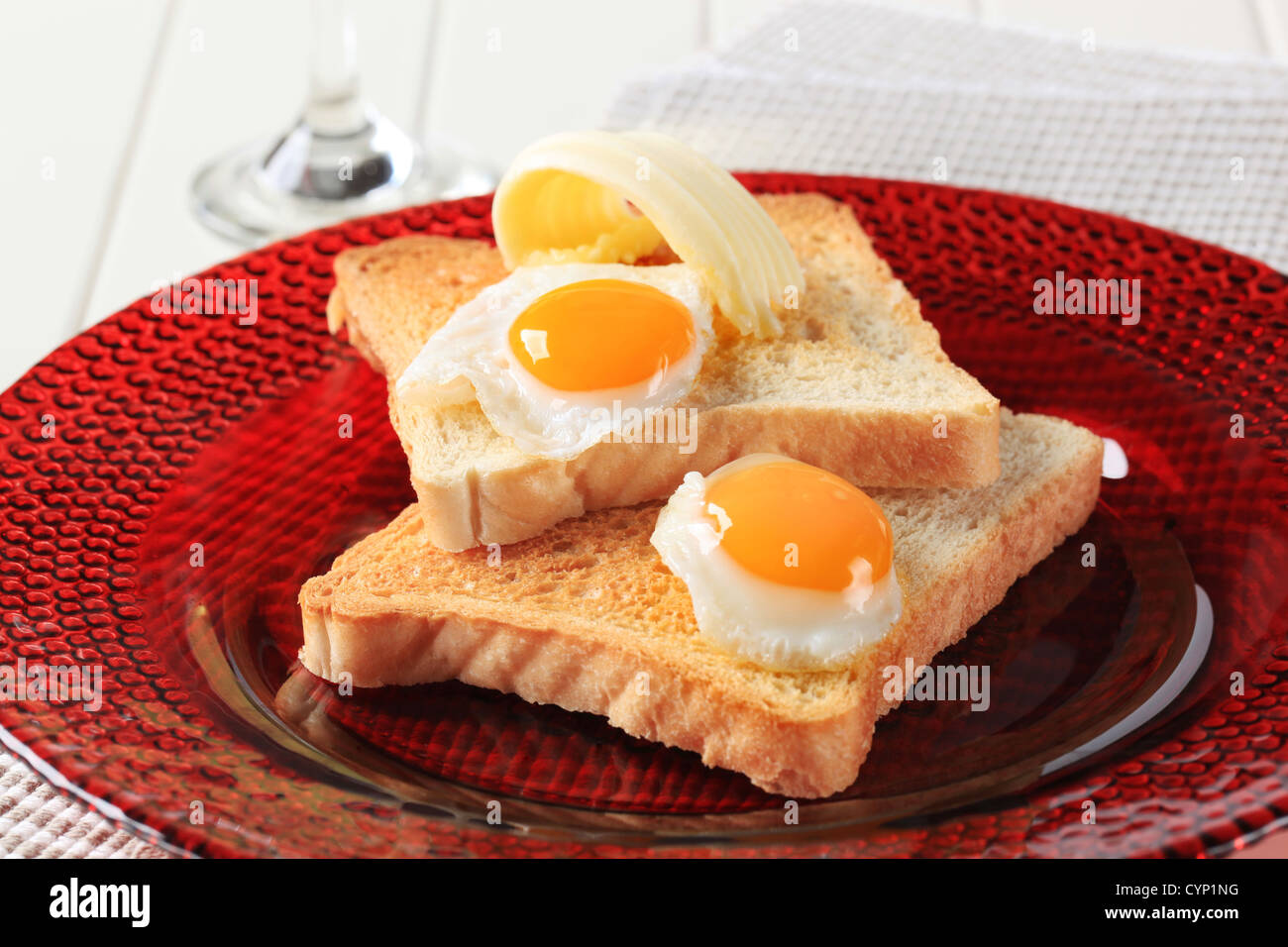 Fried eggs on slices of toasted bread Stock Photo