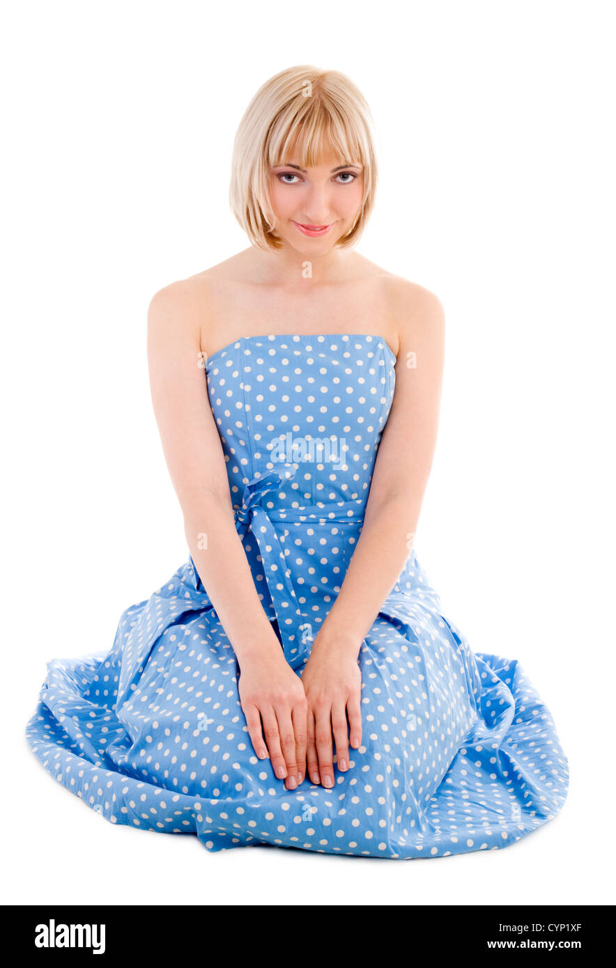 Sitting woman in blue polka dot dress on isolated white Stock Photo