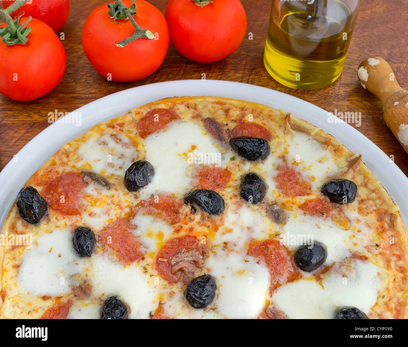 pizza with olives, pepperoni and anchovies Stock Photo Alamy