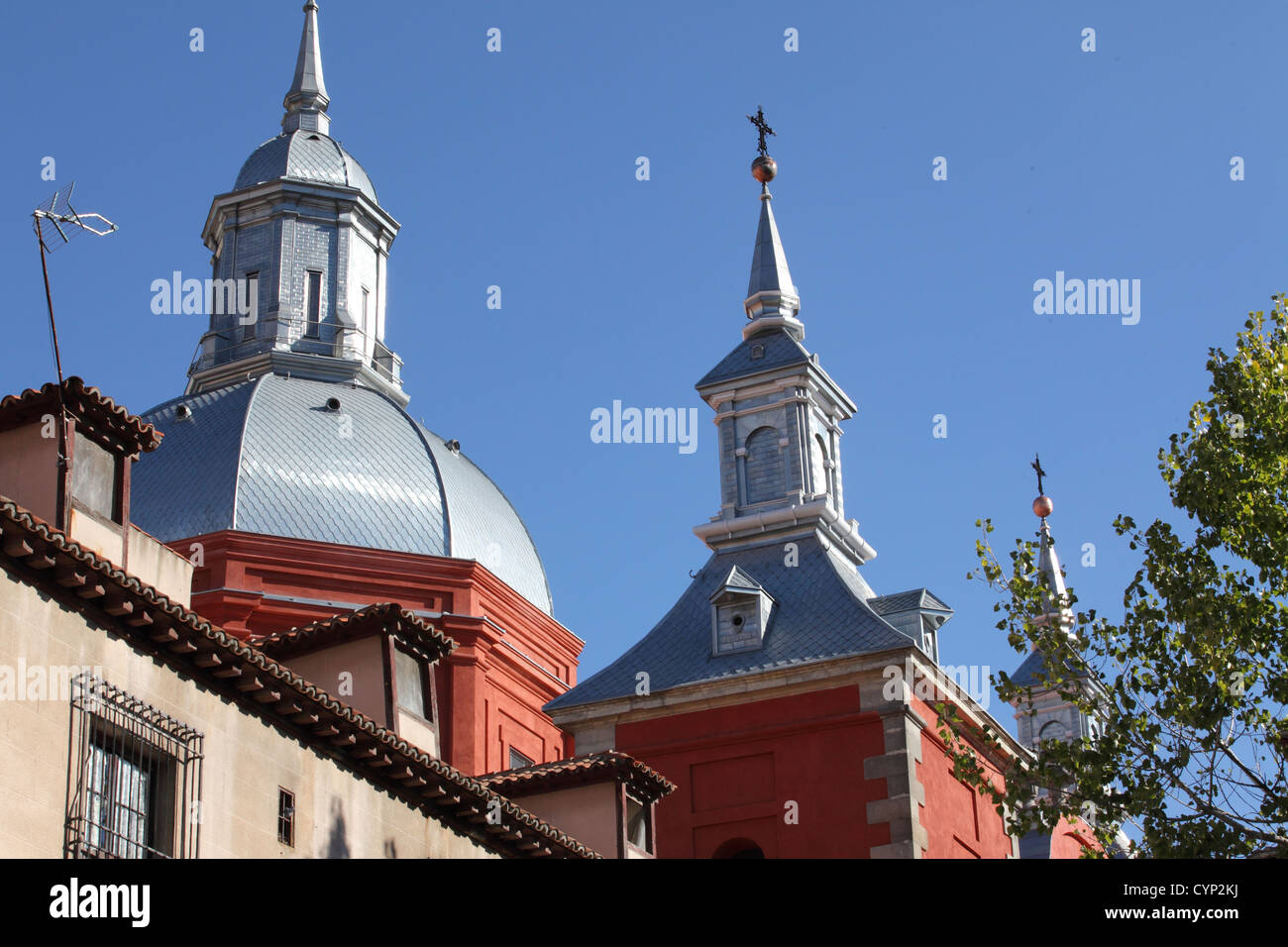 Historic traditional church Baroque roof tower detail red against blue sky, Madrid, Spain Stock Photo
