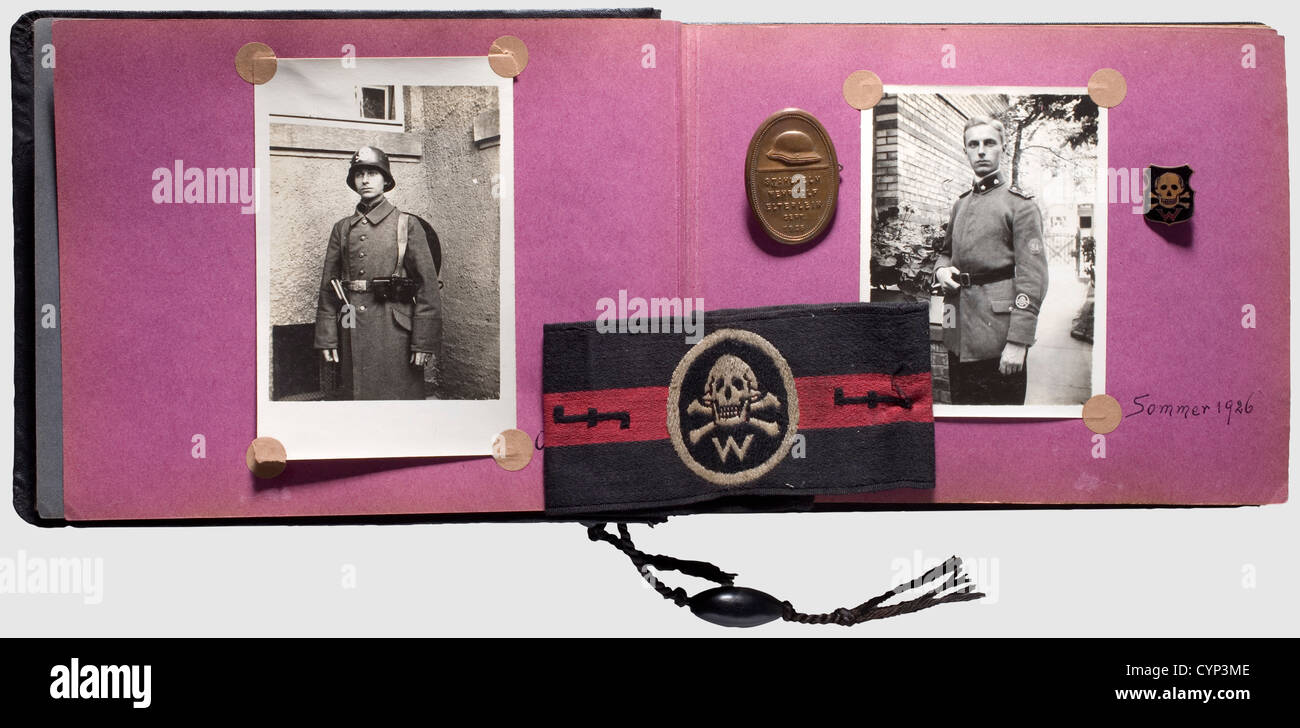 A photo album and badges of the 'Wehrwolf', Album (dented) with more than 100 photos, many of them in postcard size. Group as well as single poses with recognisable collar tabs, cap insignia, cuff titles, belt buckles, flags, gorgets, etc. marching, in camp, musical groups. Glued-in sealing bands and newspaper articles. Included armband, membership and conference badge. Very rare, historic, historical, people, 1920s, 20th century, object, objects, stills, clipping, clippings, cut out, cut-out, cut-outs, Additional-Rights-Clearences-Not Available Stock Photo