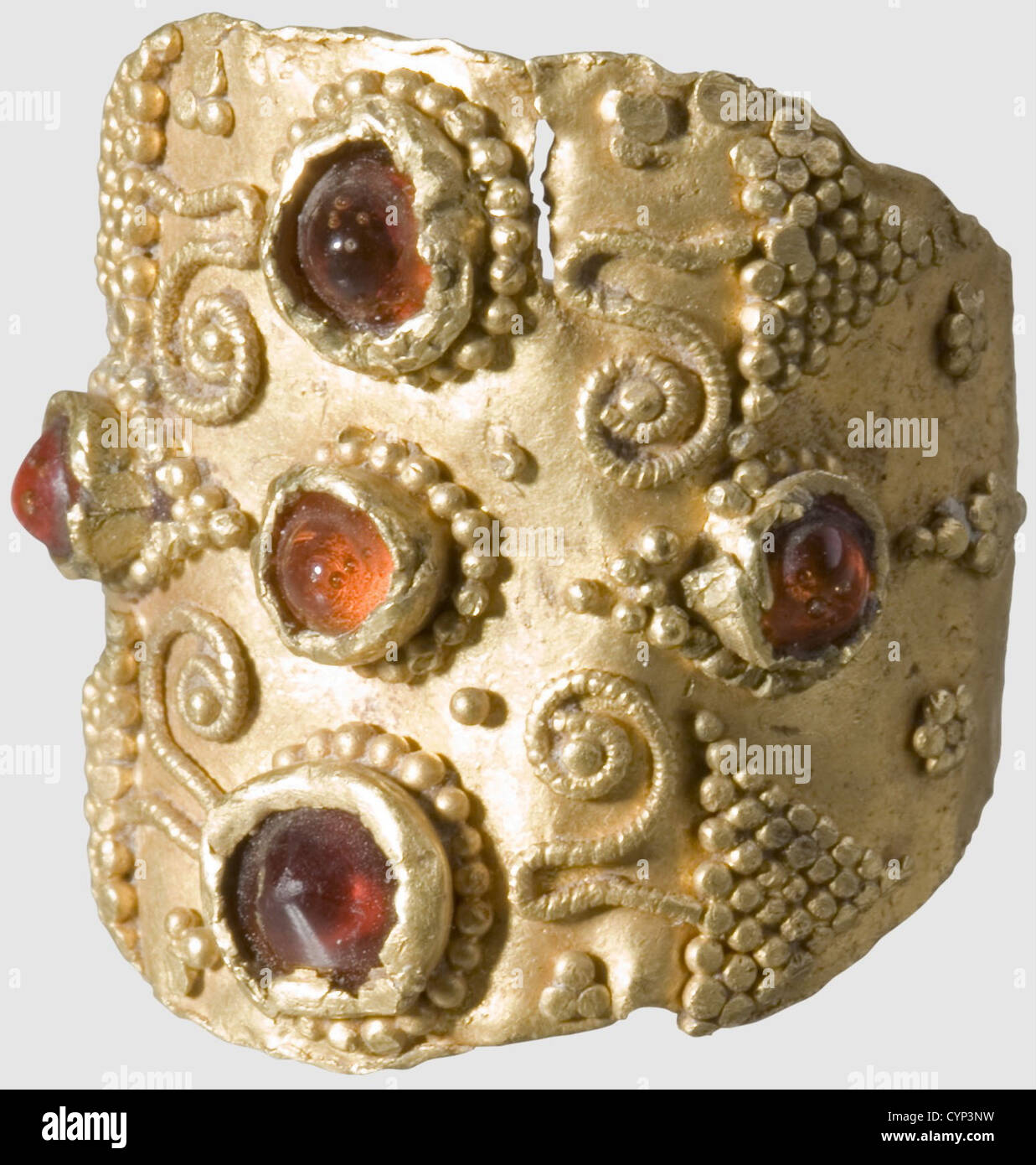A gold ring from the Early Middle Ages, Franconian, 5th/6th century A.D. Gold ring consisting of one part with granulated grape ornaments and five dark red garnets set in a cruciform pattern. Diameter 15 mm, ring plate 18 mm, weight 4.5 g The granulation particularly fine, historic, historical, ancient world, ancient world, ancient times, object, objects, stills, clipping, cut out, cut-out, cut-outs, jewellery, jewelry, noble, precious, Additional-Rights-Clearences-Not Available Stock Photo