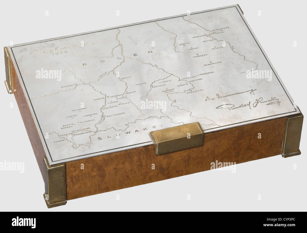 A silver presentation cigarette box for the 1939 Polish campaign,10th Mounted Rifles Regiment.Cedar with figured amboine veneer.Brass corners and feet.Silver lid engraved with a map of Poland and 'Feldzug in Polen 1939'(Campaign in Poland 1939)on the upper left,and 'In Erinnerung Rudolf Kinsky'(In Memory - Rudolf Kinsky)at the lower right.A detailed enumeration of the(transl.)'Movements and Actions Fought by the 10th Mounted Rifle Regiment from 1 September to 24 September 1939' inside.The silversmith's signature 'Carl Hiess Wien I',the hallmark '9,Additional-Rights-Clearences-Not Available Stock Photo
