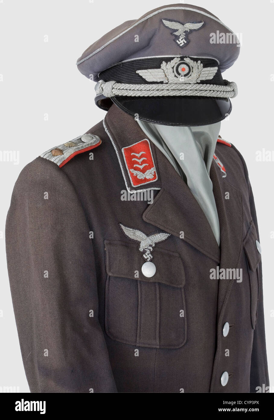 A walking-out uniform for a Hauptmann,of Flak Artillery.Visor cap of blue gabardine with black mohair band,silver piping and silver-embroidered insignia,silver cord.Bluish silk liner with gold stamped label 'Litto-Mütze Wien Sonderklasse'.Sweatband in poor condition,equipment stamped.Coat of Luftwaffe blue gabardine with silver buttons,silver-embroidered eagle and collar patches,sewn-on shoulder boards and collar cord.Silk liner in poor condition,moth damage.Breeches of blue gabardine with leather trim.Officer's dagger with white grip,hanger worn,Additional-Rights-Clearences-Not Available Stock Photo