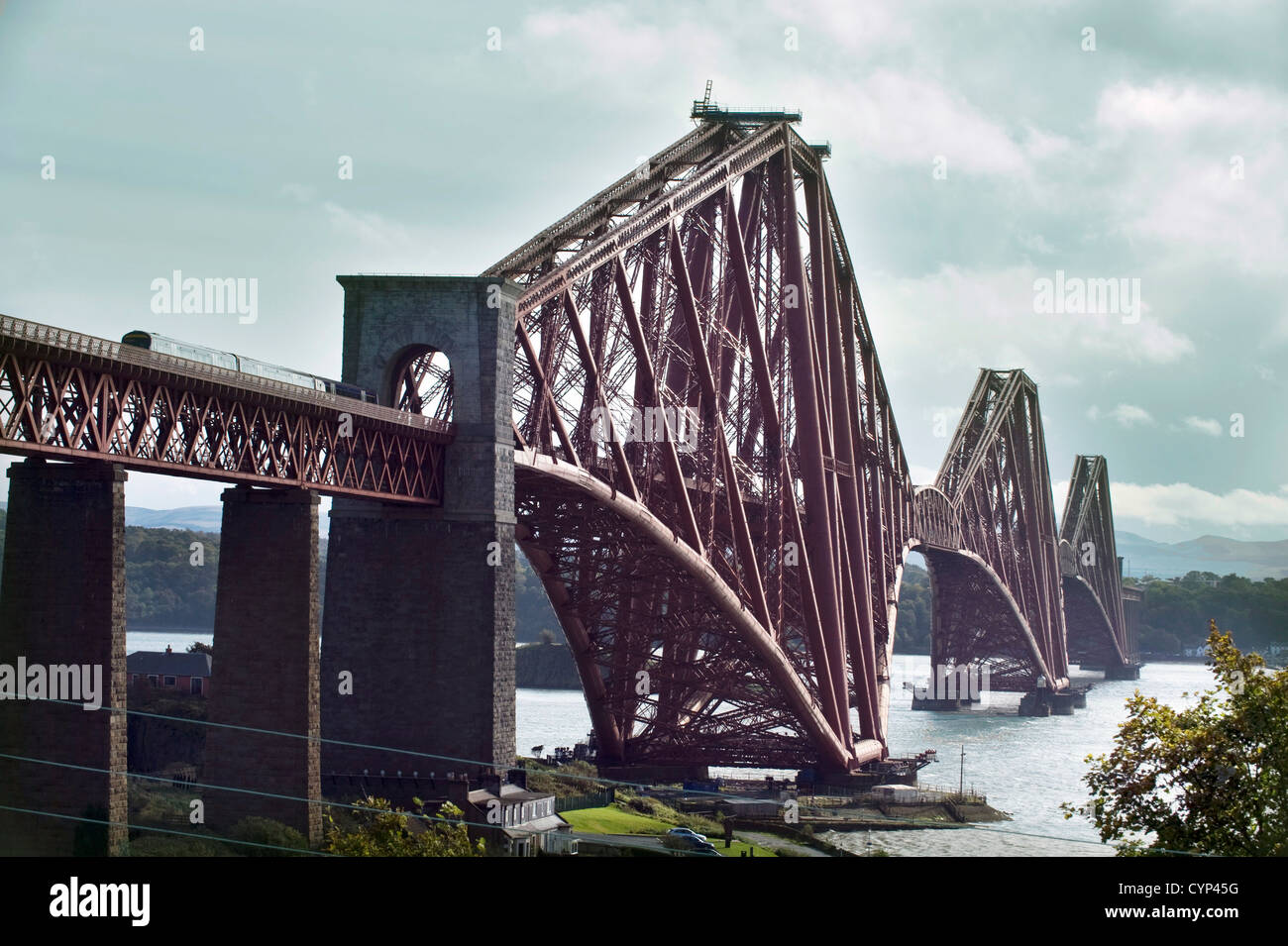 A ScotRail train crossing the 2.5 km ( 1.5 mile) long newly painted Cantilever Forth Railway Bridge Stock Photo