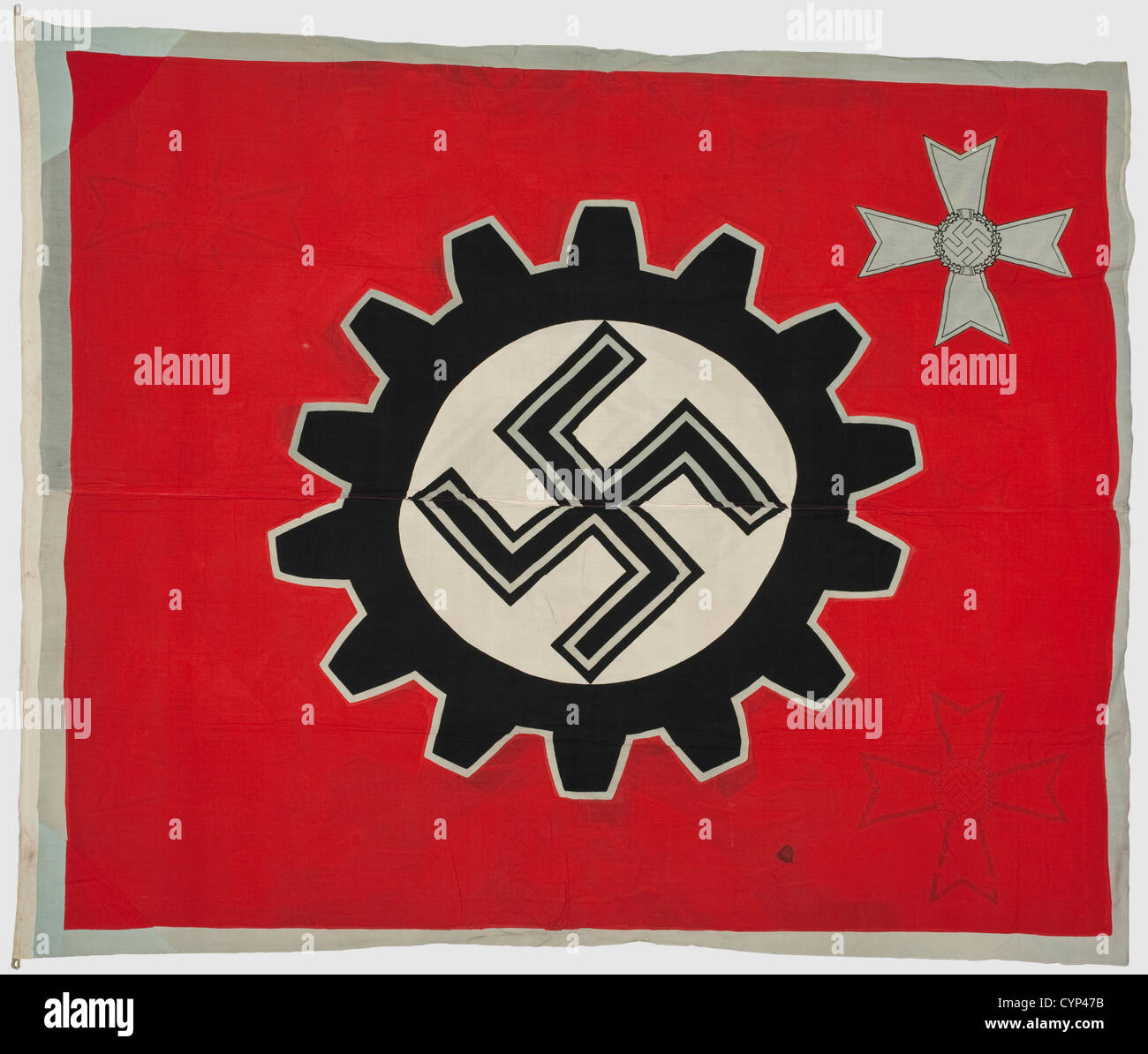 A flag for war model plants,of polychrome printed flag linen with silver grey edging and a War Merit Cross depicted in the upper right corner,sewn together of several pieces,two fastening loops,manufacturer 'Fahnen Hoffmann K.G.Berlin'.Signs of storage,colour marks from other flags.Dimensions ca.220 x 240 cm.With a large decorative certificate with embossed national eagle for the factory collective Elektron-Co.m.b.H.Spandau from 1 January 1943 with Adolf Hitler's ink signature.Foxed.The gold-embossed eagle on the folder blacked out.Ca.64 x 47 cm,,Additional-Rights-Clearences-Not Available Stock Photo