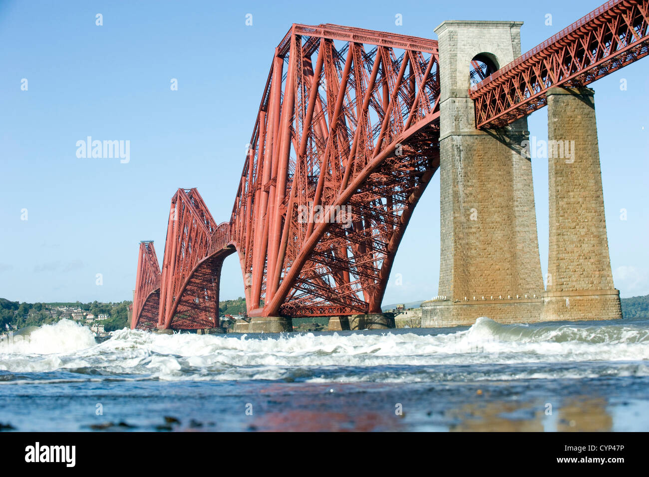 The newly painted (2012) Forth Bridge pictured from the shore of the Firth of Forth at South Queensferry, Fife Scotland. Stock Photo